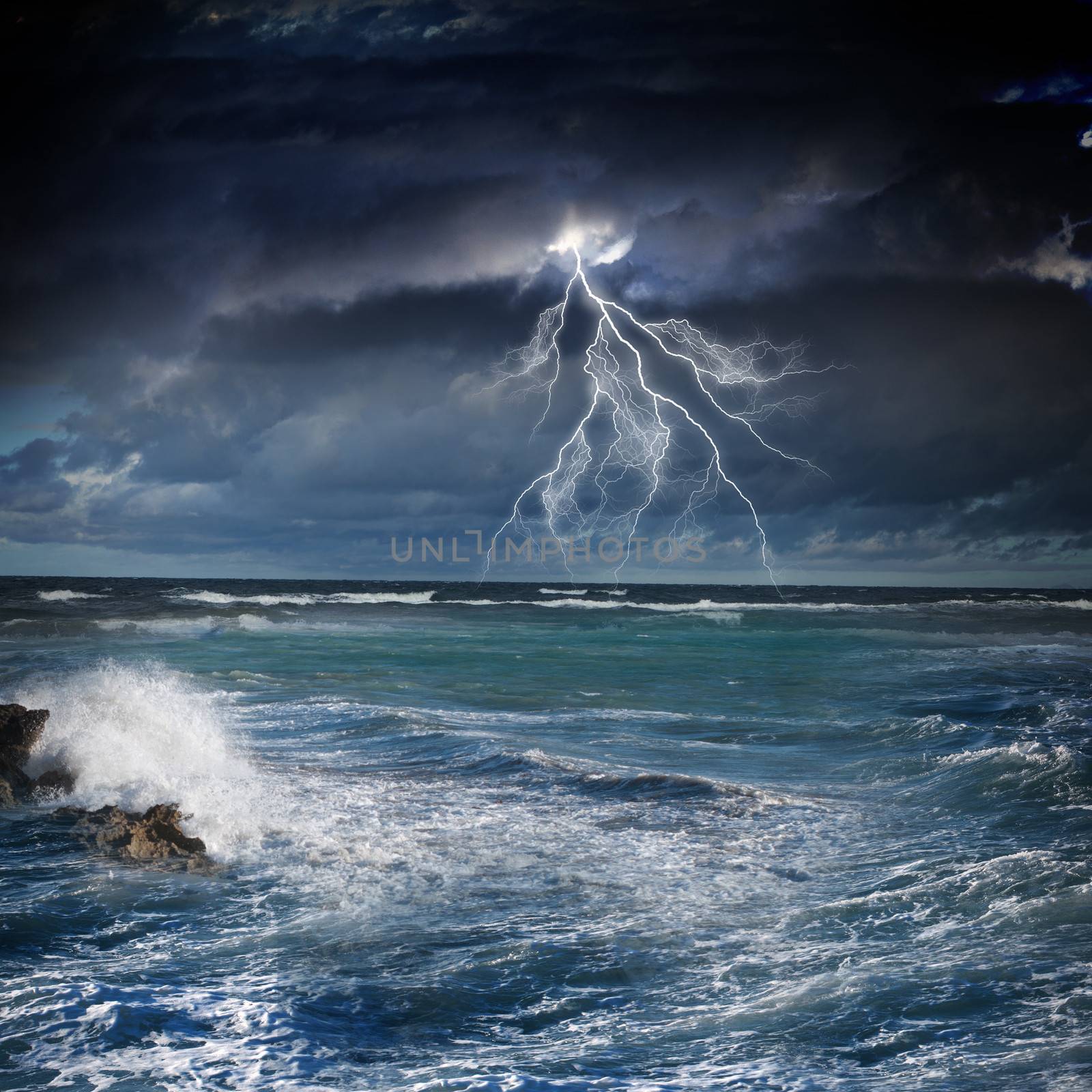 Image of night stormy sea with big waves and lightning