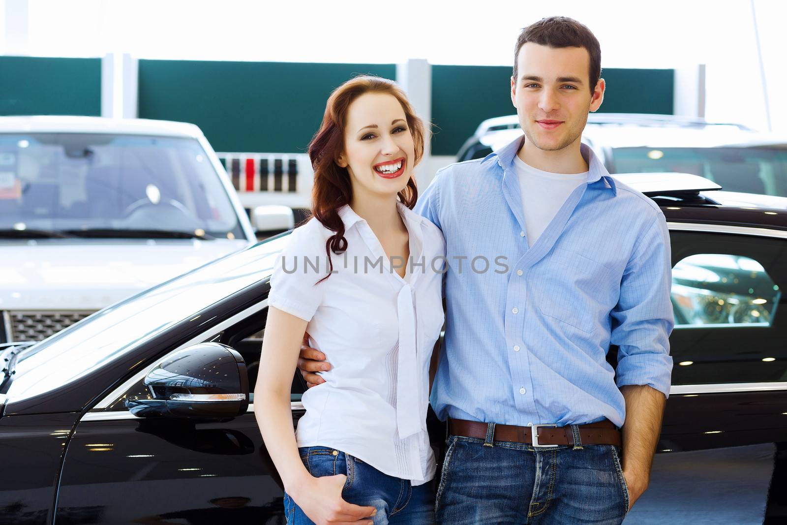 Young happy couple at car salon by sergey_nivens