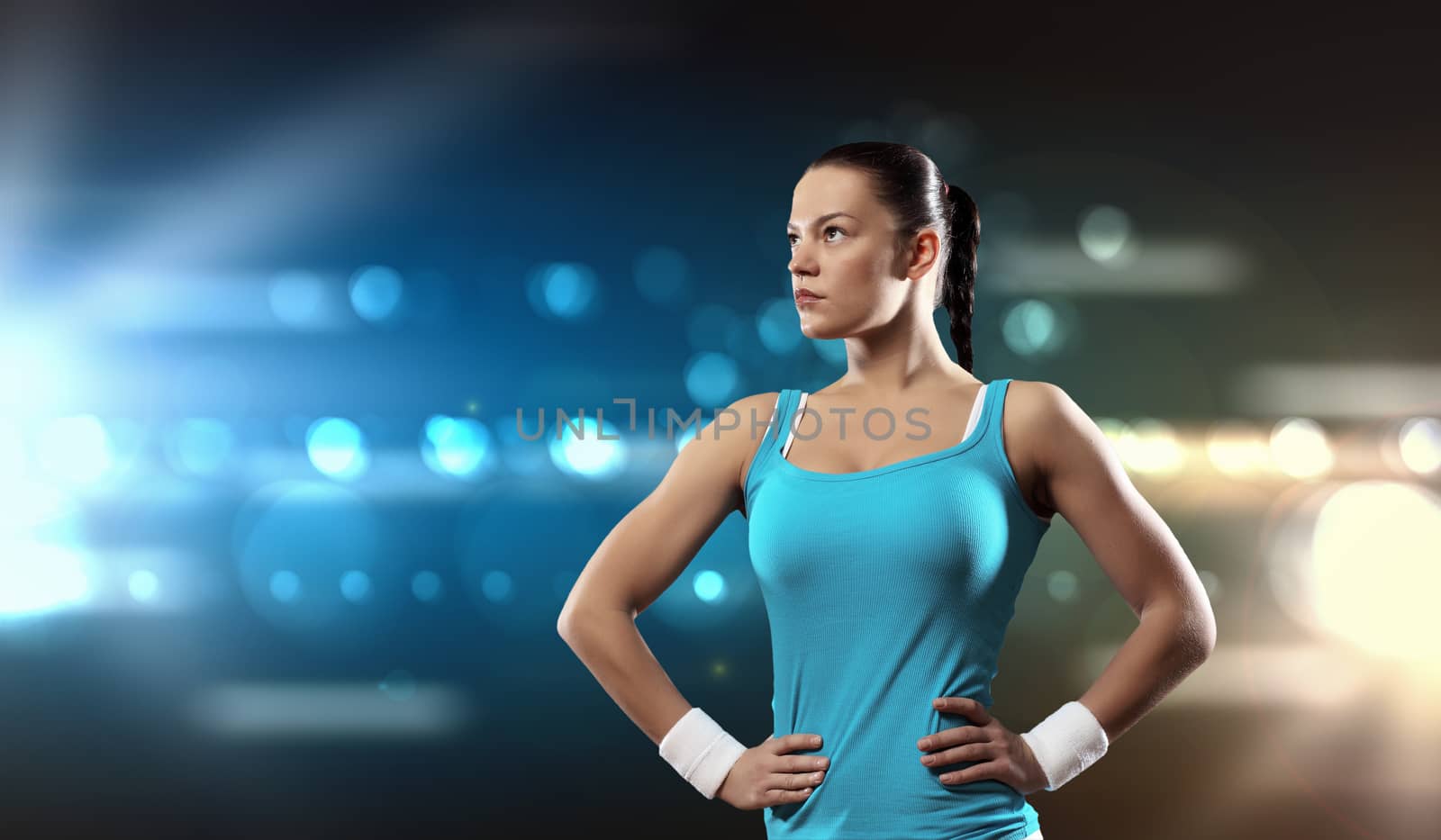 Image of sportswoman standing against lights background