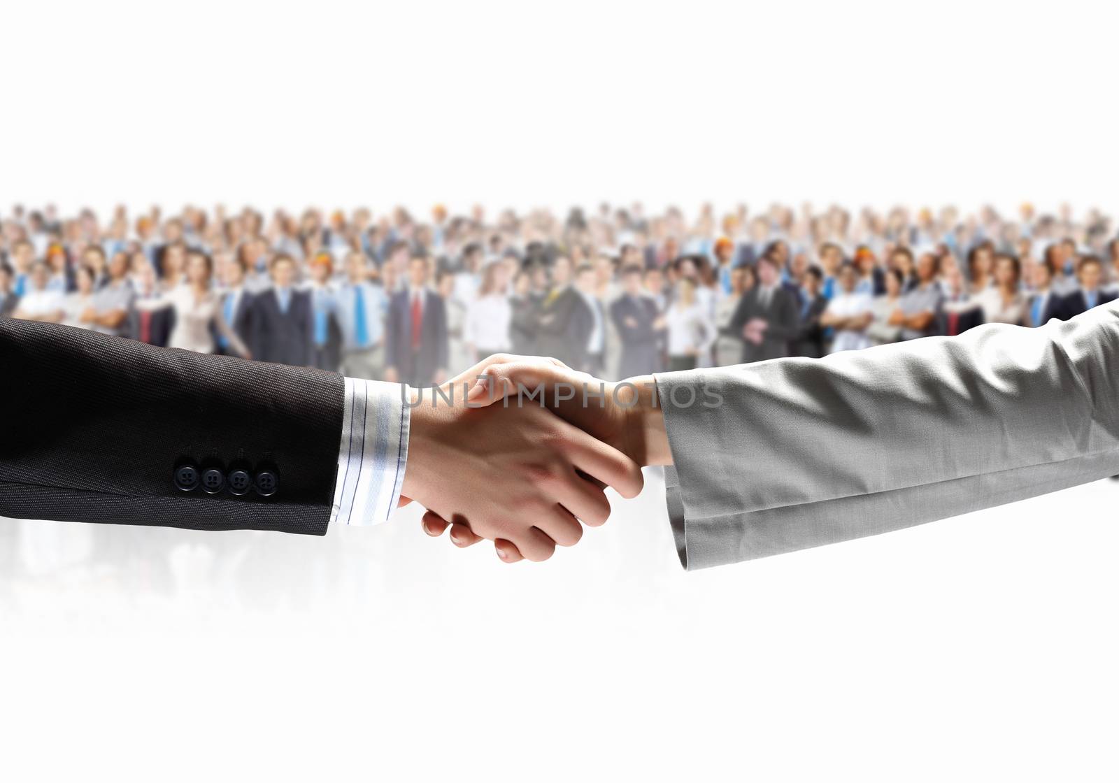 Handshake of business people with people at background