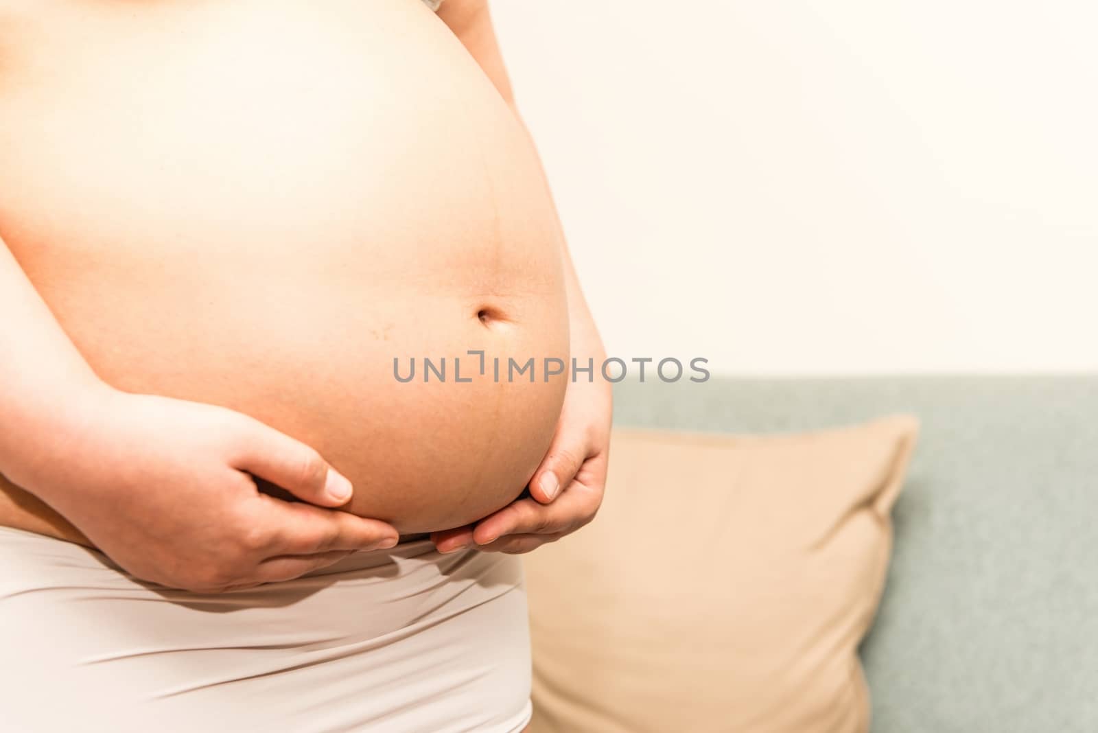 6 months Asian Thai woman pregnant belly by sasilsolutions