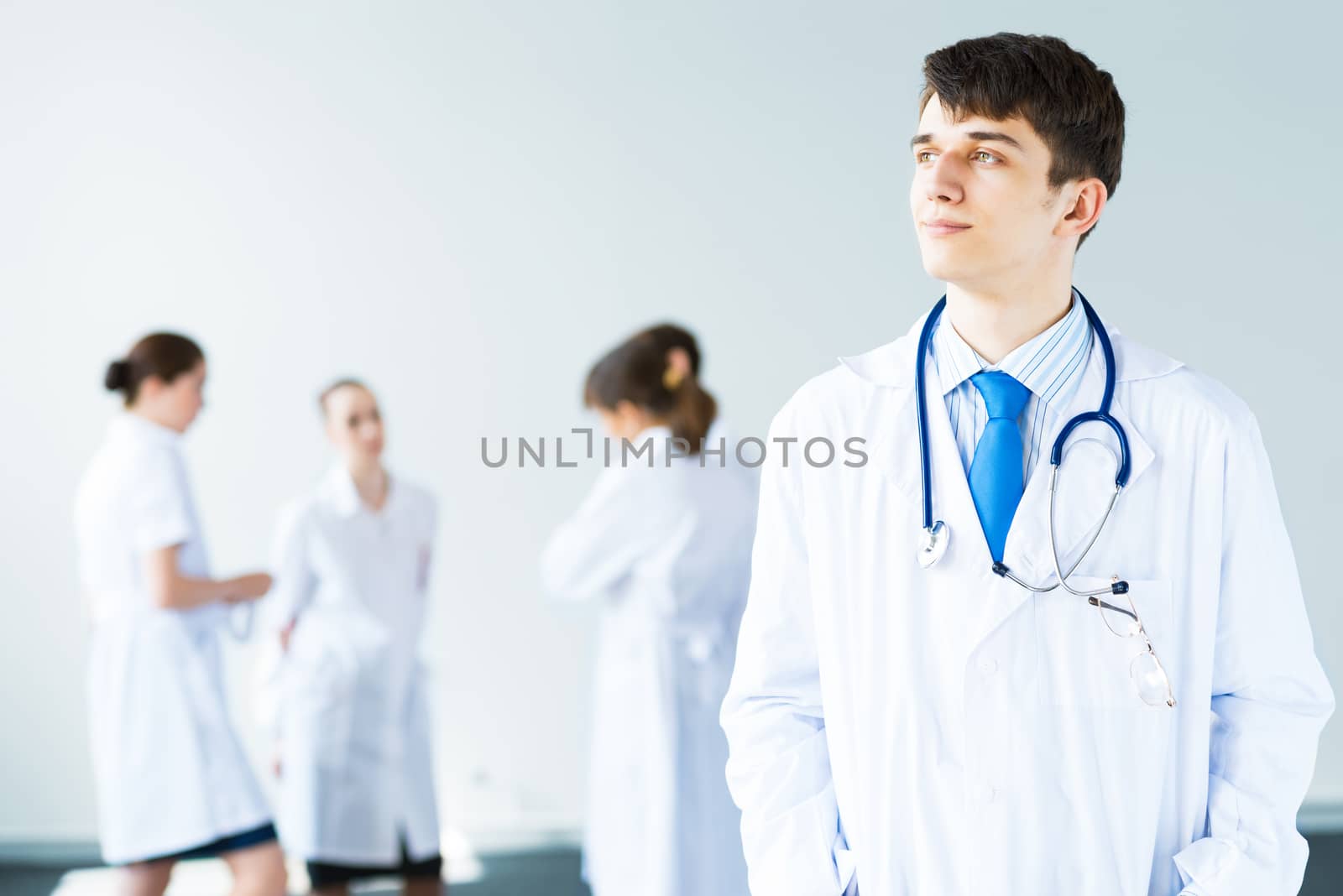 Portrait of a successful young doctor and hospital staff