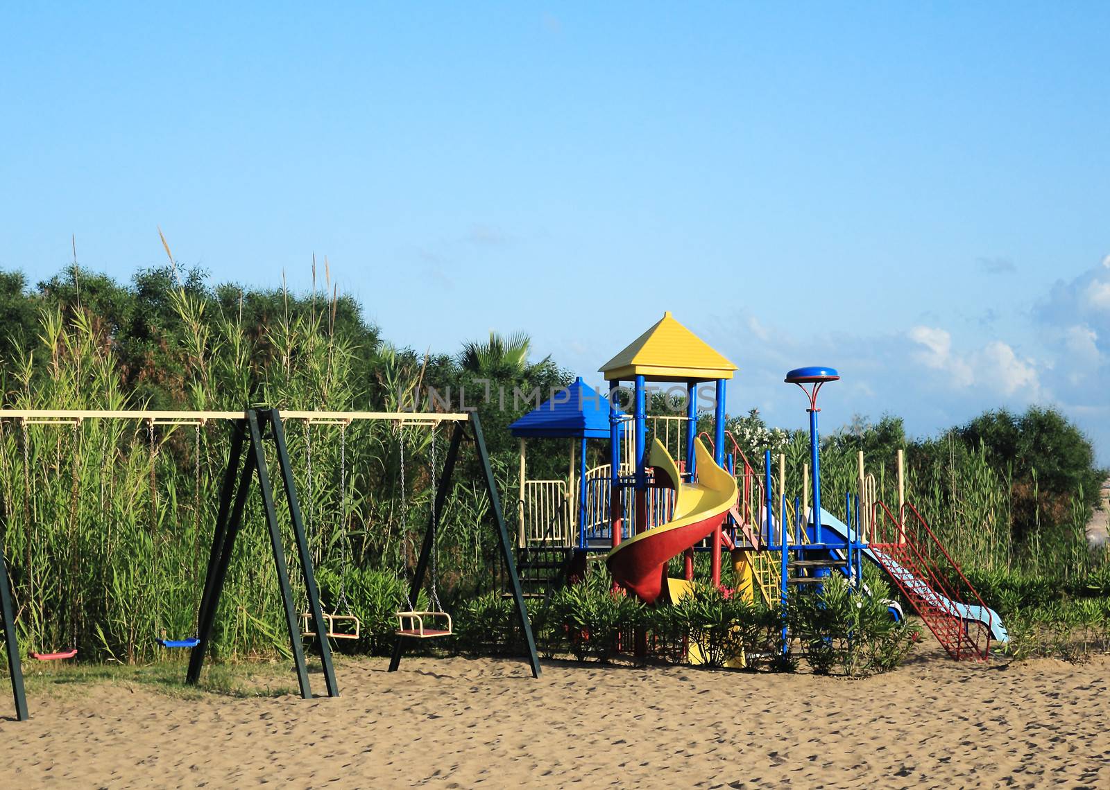 Children's Playground with many attractions on the beach in the resort.