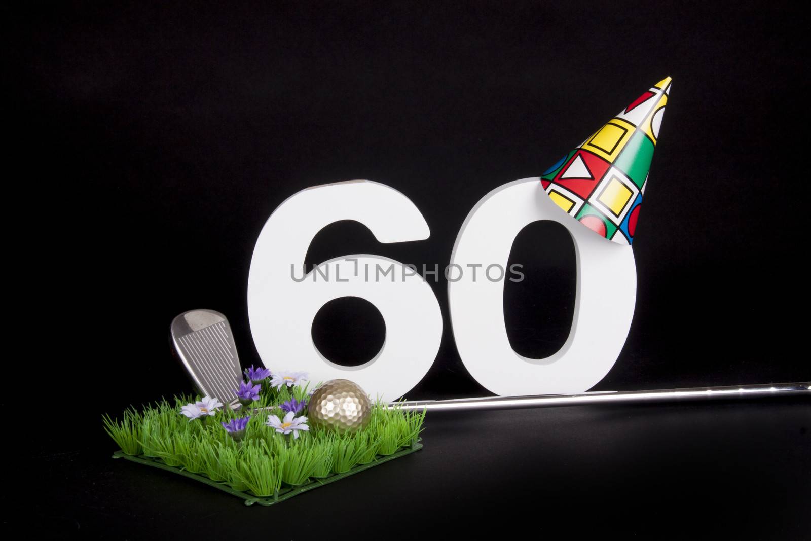 A golf club and golf ball on an artificial peace of grass to be used as a birthday card