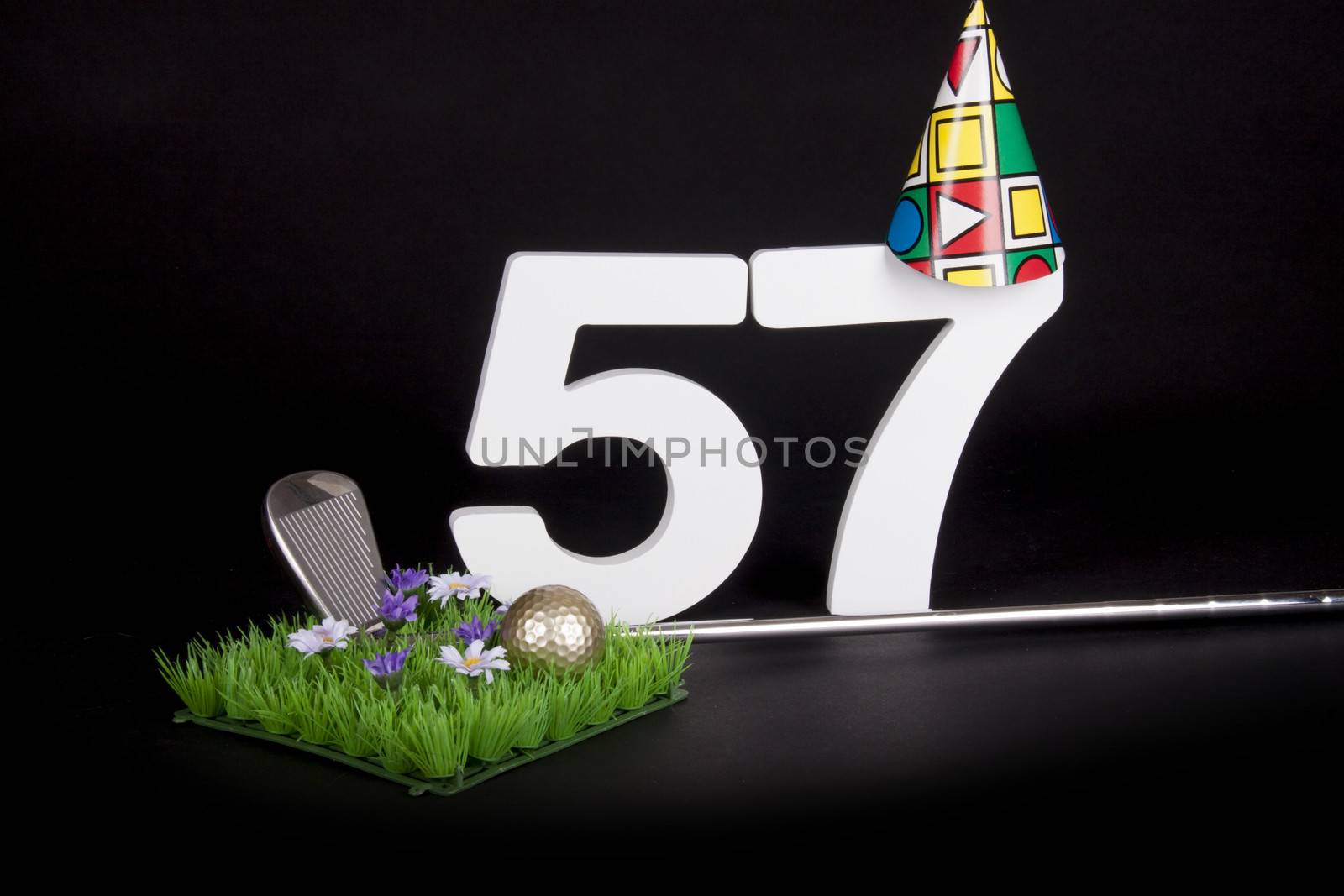 A golf club and golf ball on an artificial peace of grass to be used as a birthday card