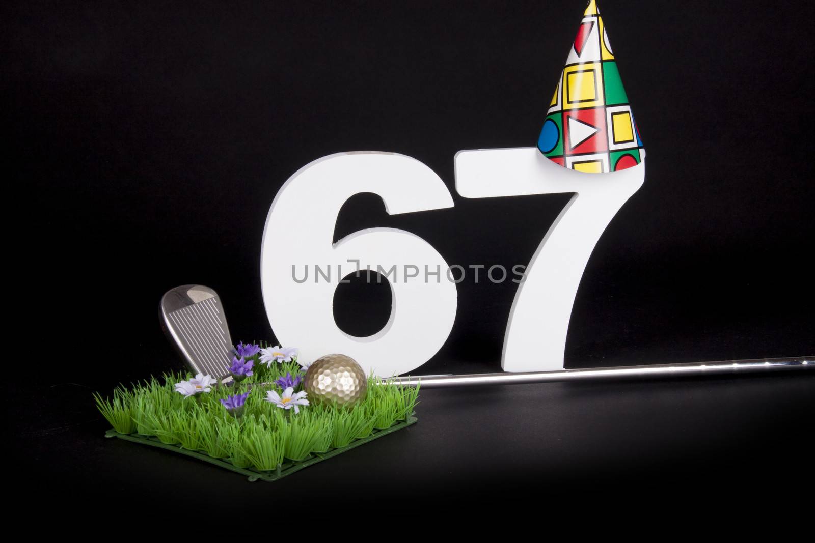 A golf club and golf ball on an artificial peace of grass to be used as a birthday card