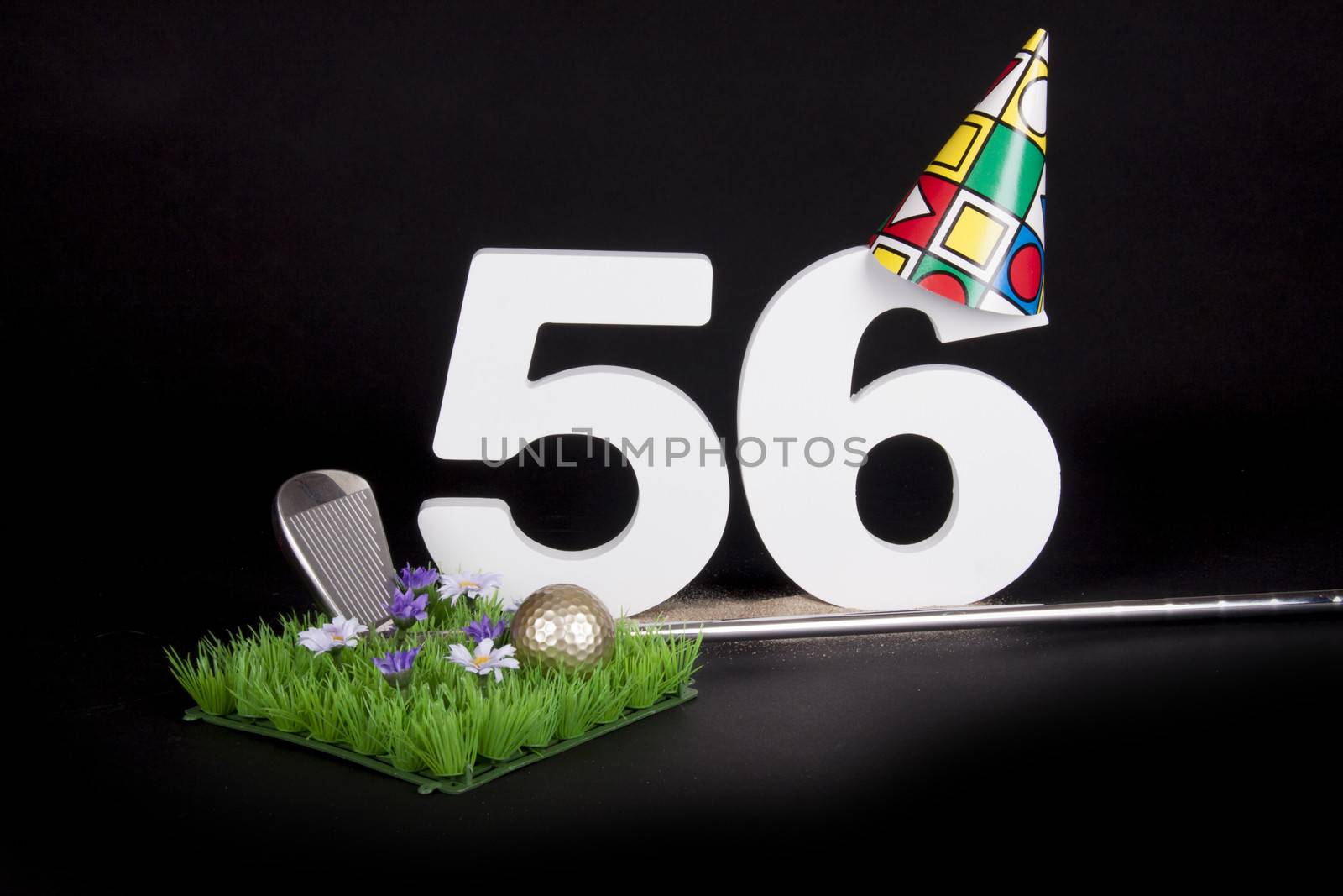 A golf club and golf ball on an artificial peace of grass to be used as a birthday card