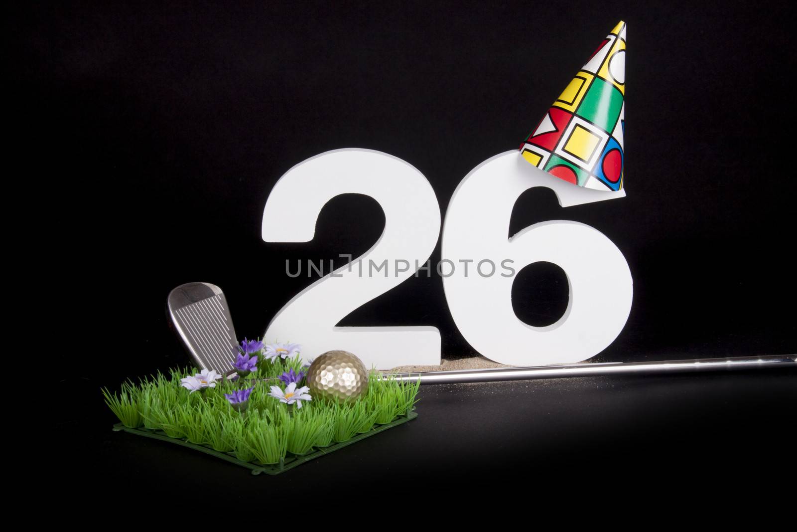 A golf club and golf ball on an artificial peace of grass to be used as a birthday card