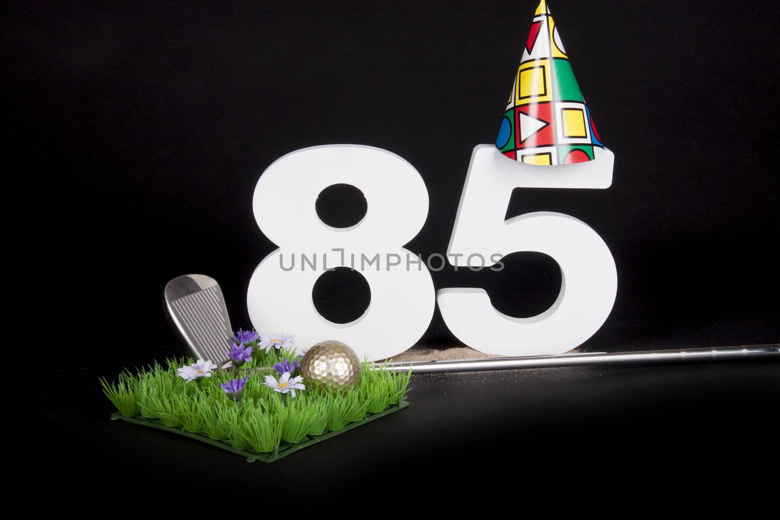 A golf club and golf ball on an artificial peace of grass to be used as a birthday card