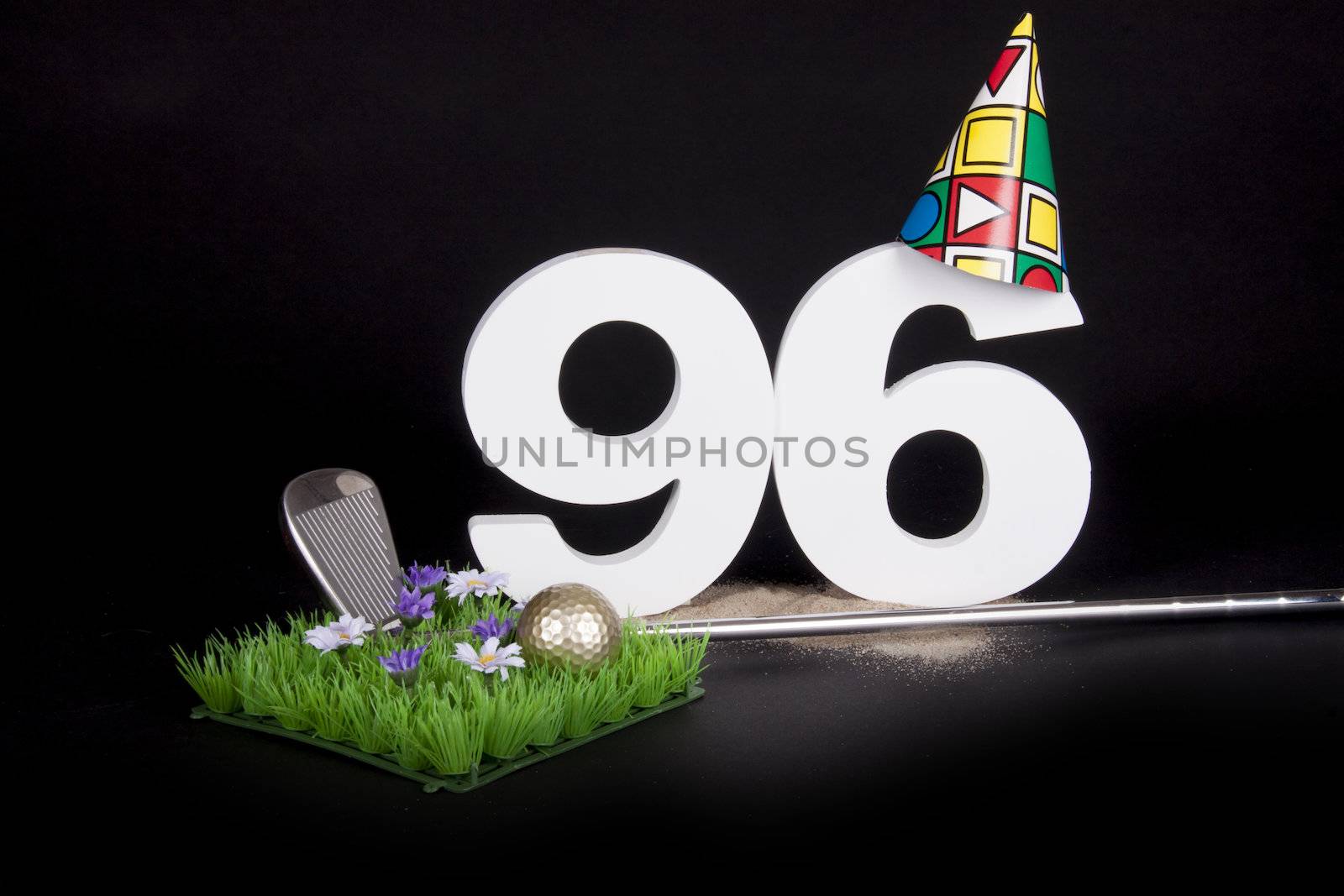 A golf club and golf ball on an artificial peace of grass to be used as a birthday card