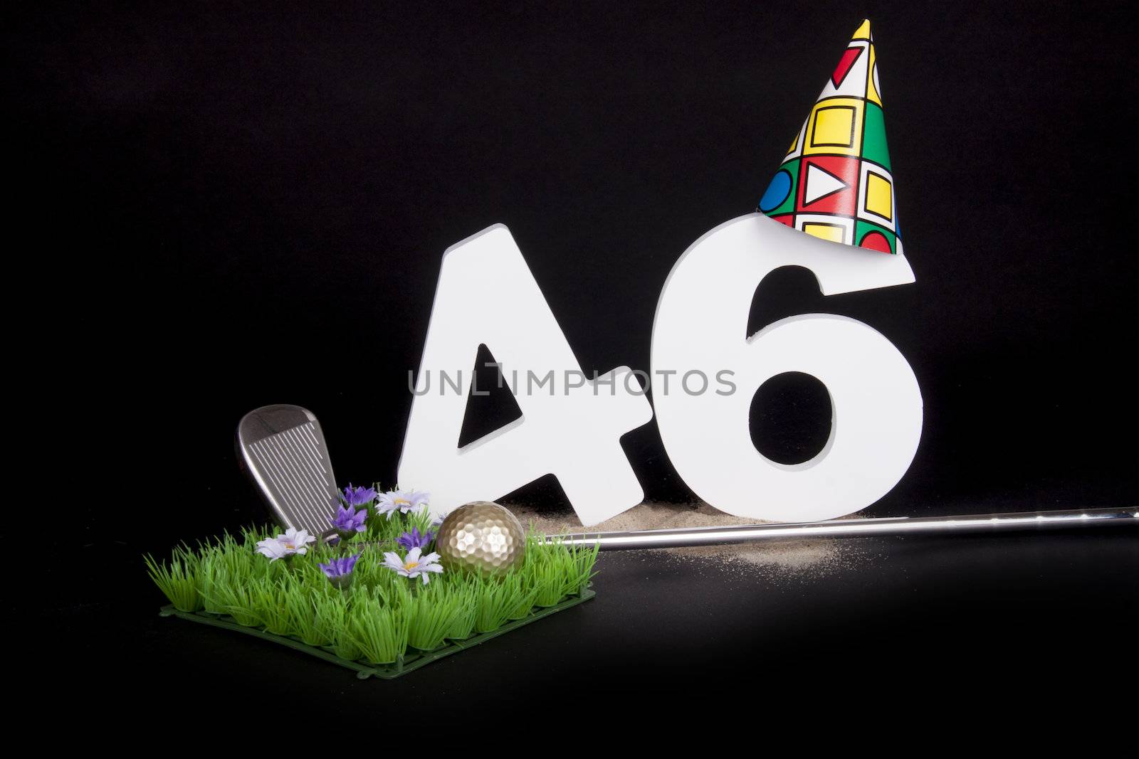 A golf club and golf ball on an artificial peace of grass to be used as a birthday card