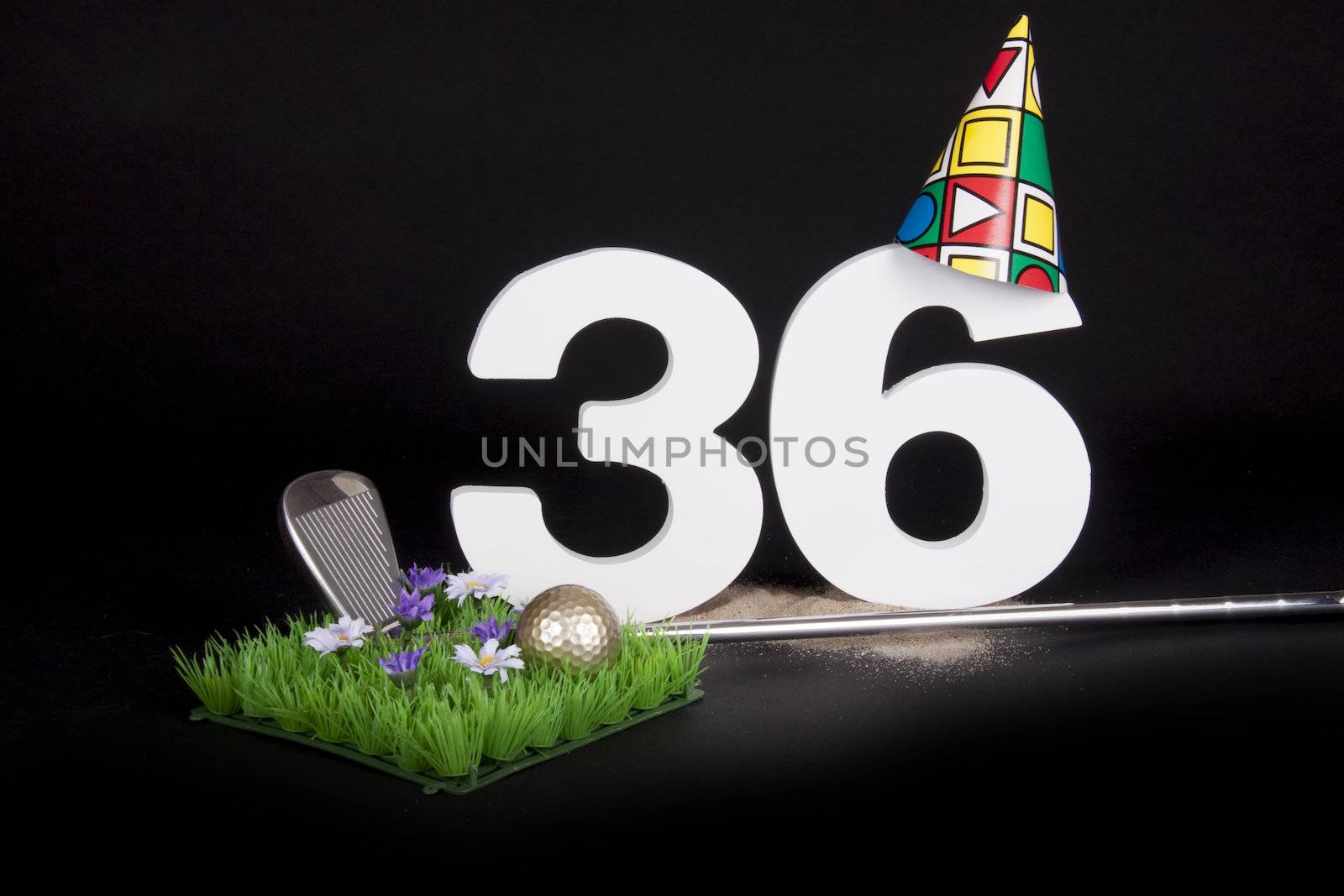 A golf club and golf ball on an artificial peace of grass to be used as a birthday card