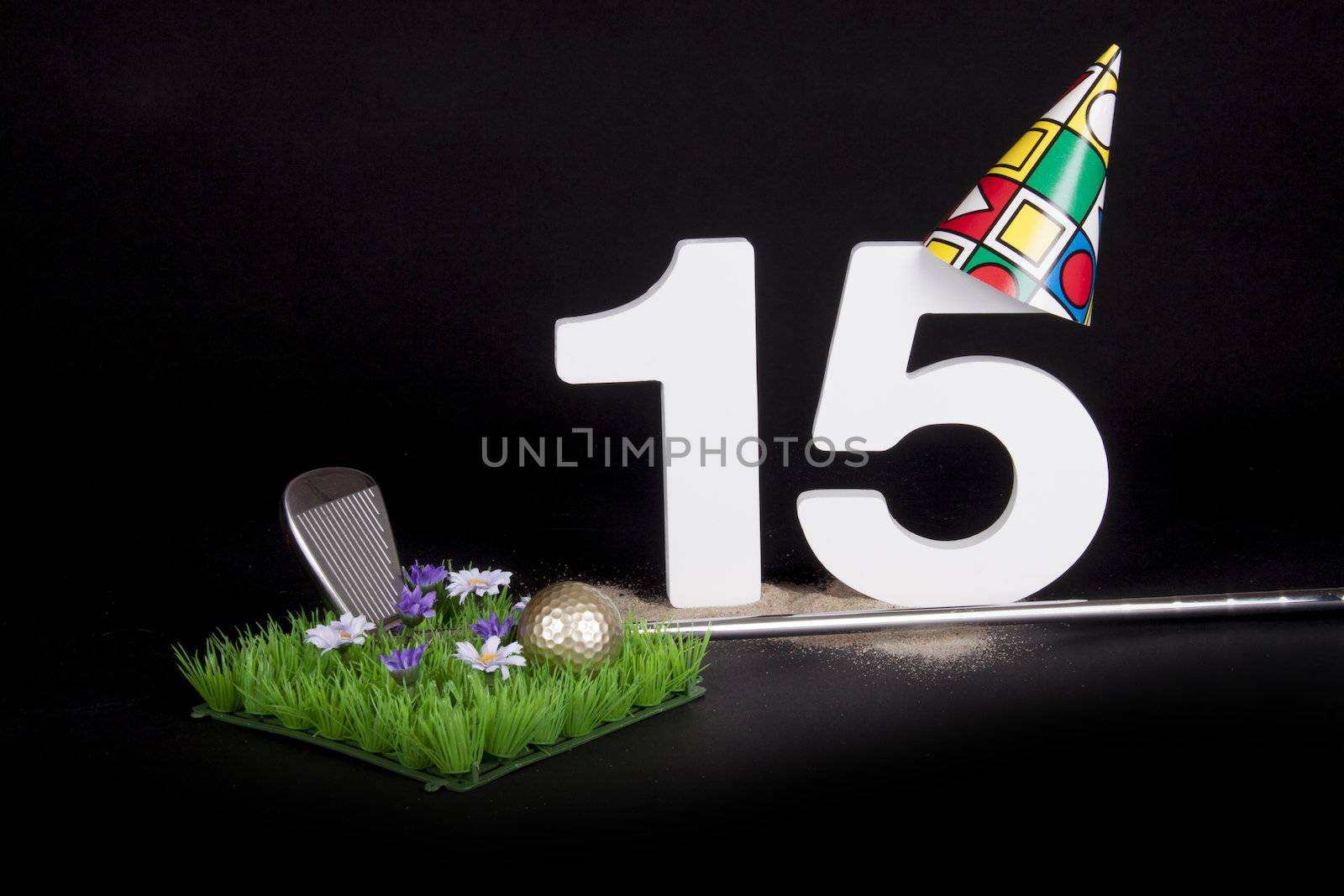 A golf club and golf ball on an artificial peace of grass to be used as a birthday card