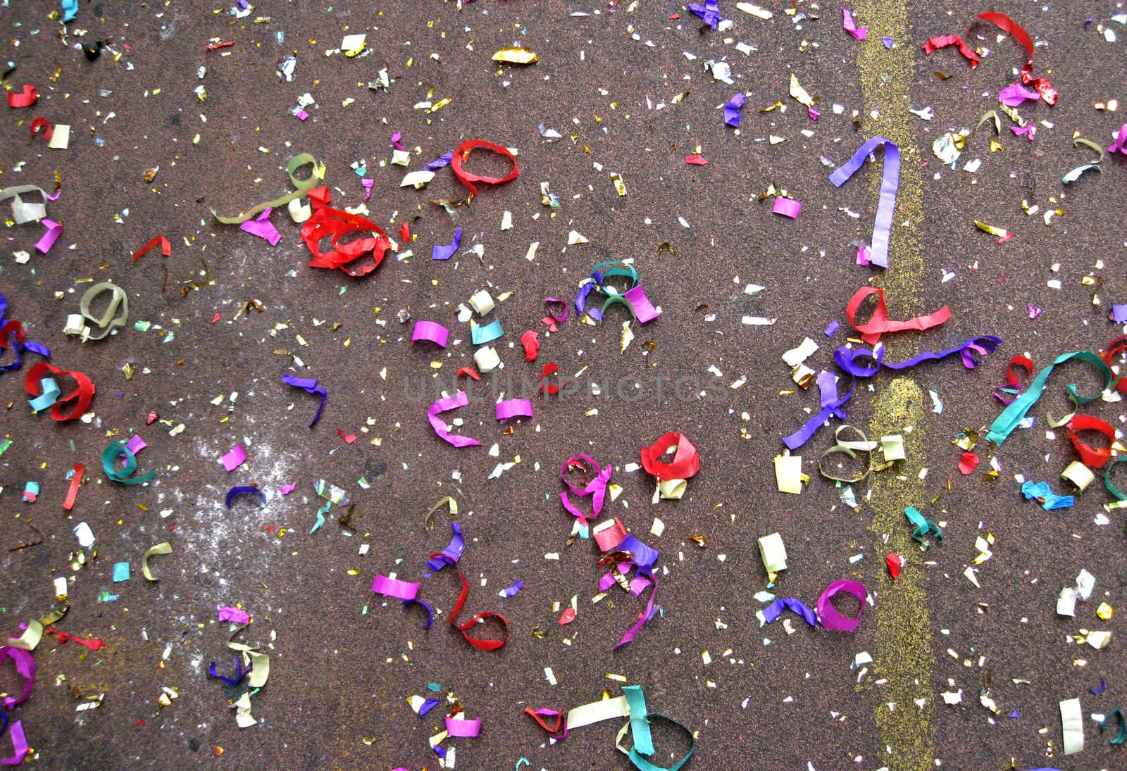 Colorful confetti in street after Chinese New Year parade 