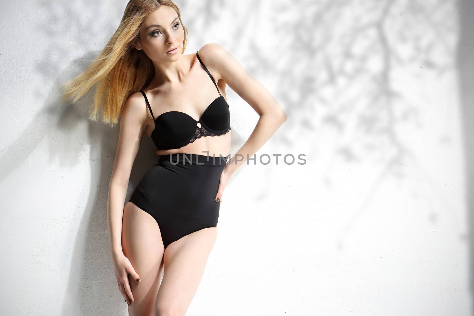Beautiful girl in black underwear isolated on white background