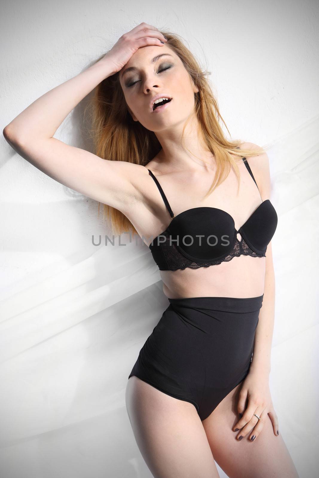 Beautiful girl in black underwear isolated on white background by robert_przybysz