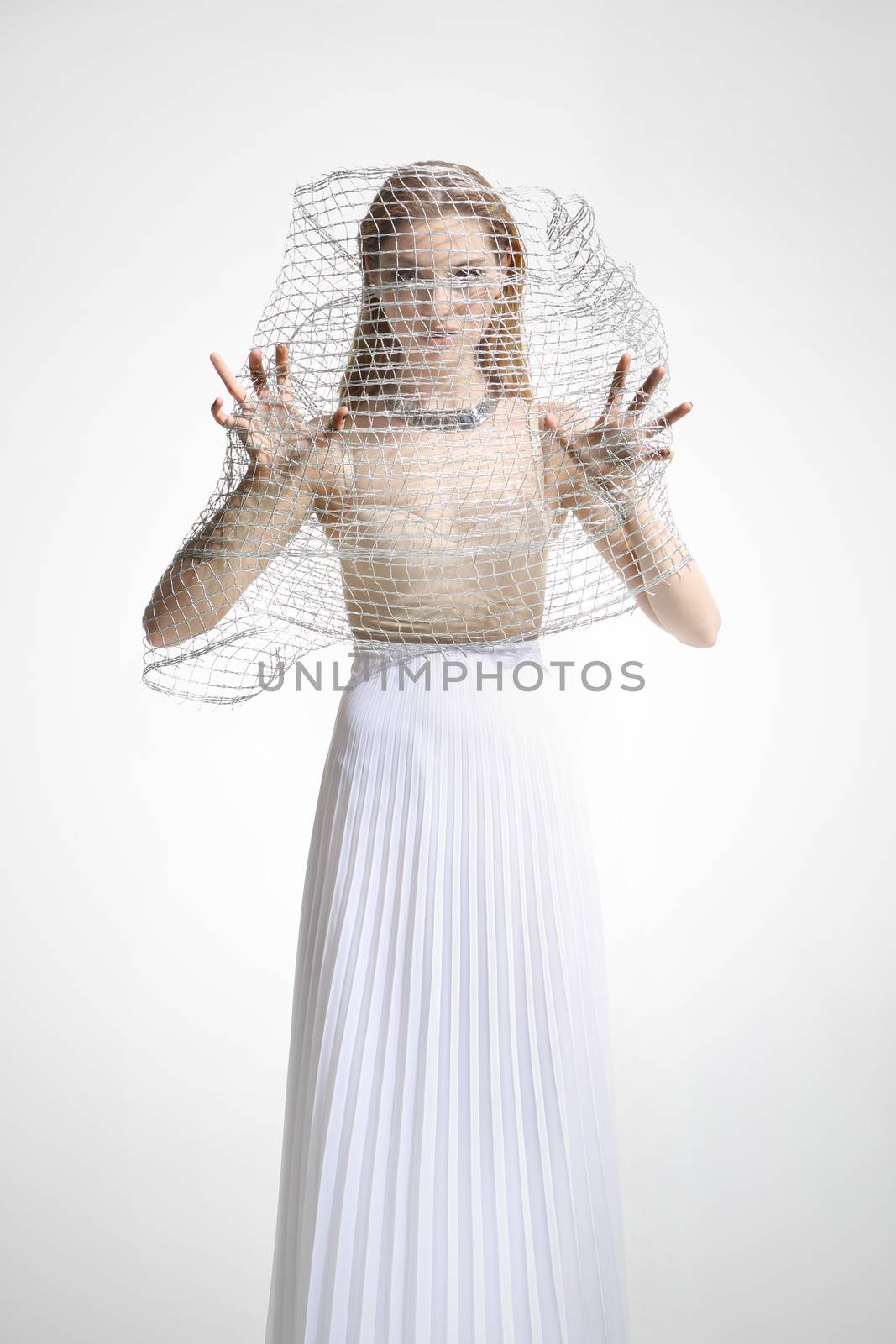 Beautiful girl in a white dress covered with a mesh isolated on white background by robert_przybysz