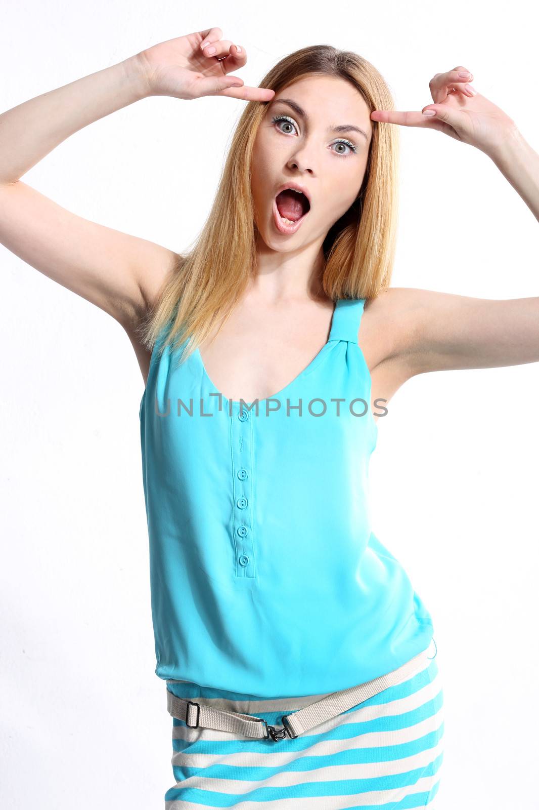 Image of a cute teenage girl pointing at her brains, isolated on white background.