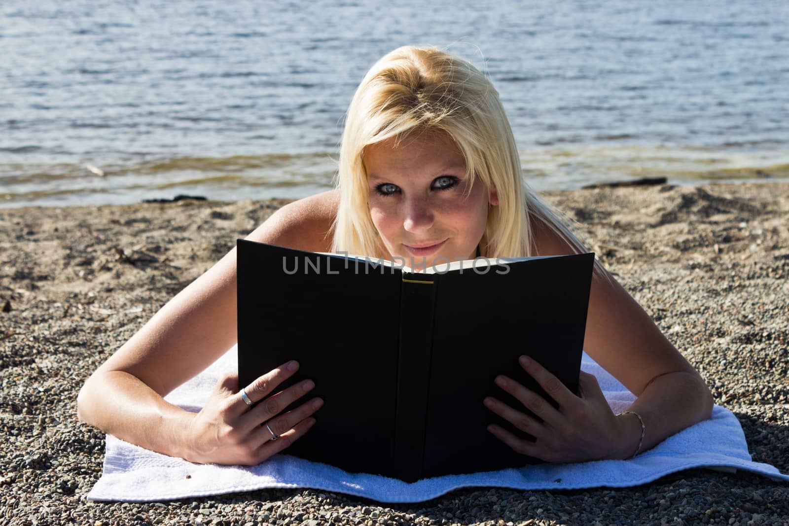 Woman reading a book on the beach