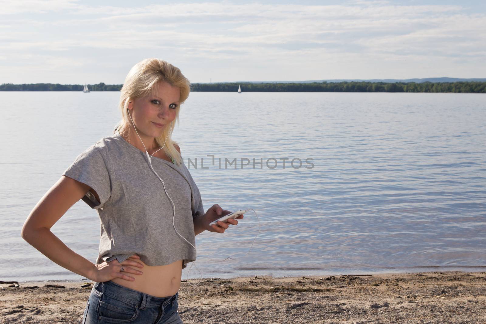 Young woman on the beach listening to music