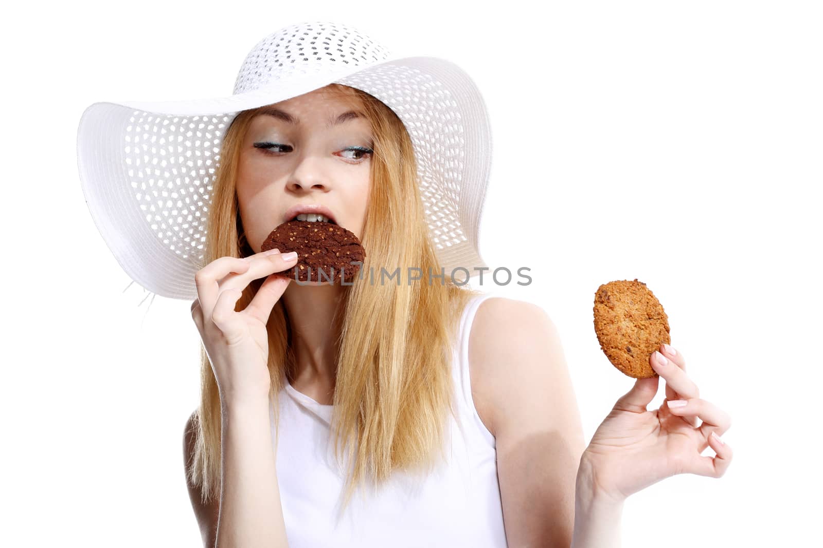 Cute young woman eats cookies on the white background by robert_przybysz