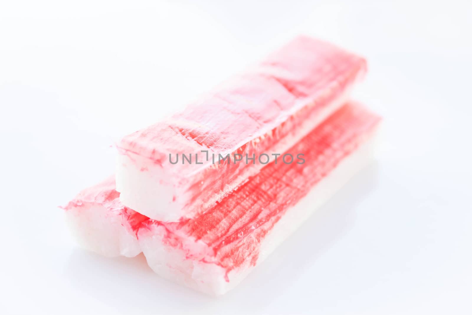 Close up pieces of crab sticks isolated on white background, stock photo