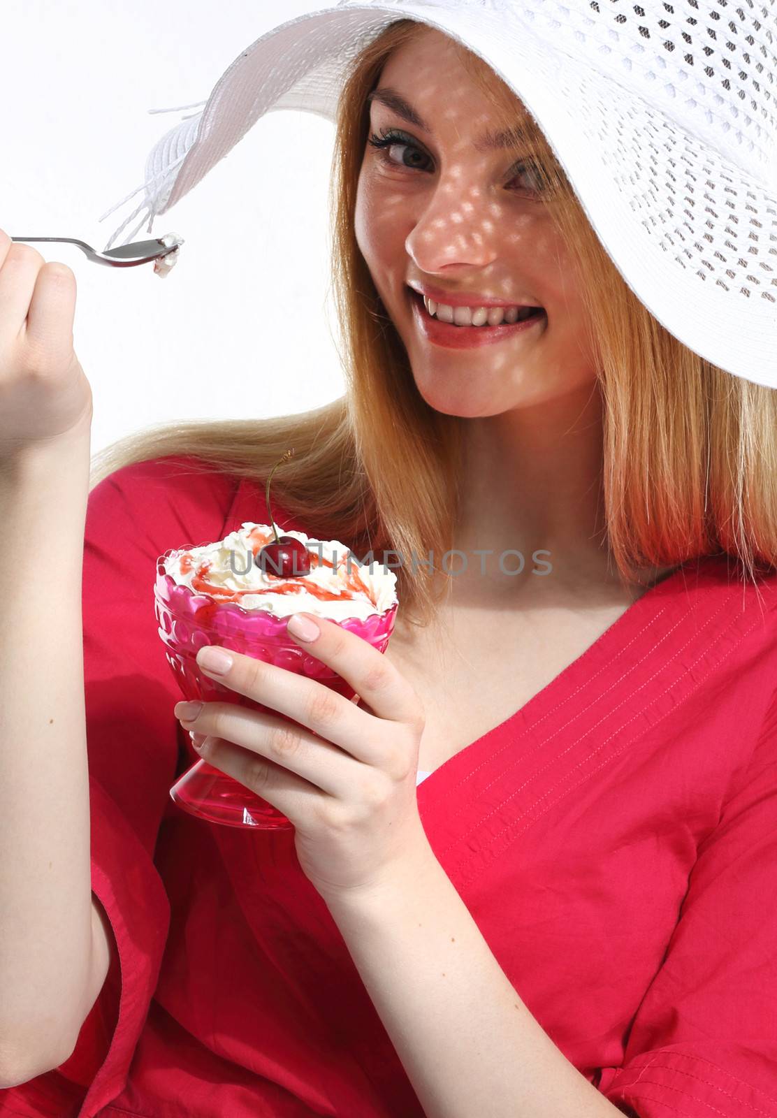 Cute woman in red with dessert on the white background
