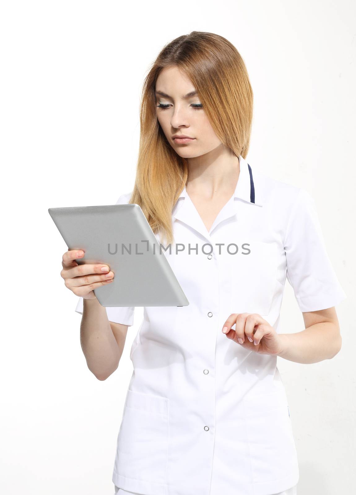 Female doctor working on digital tablet on white background