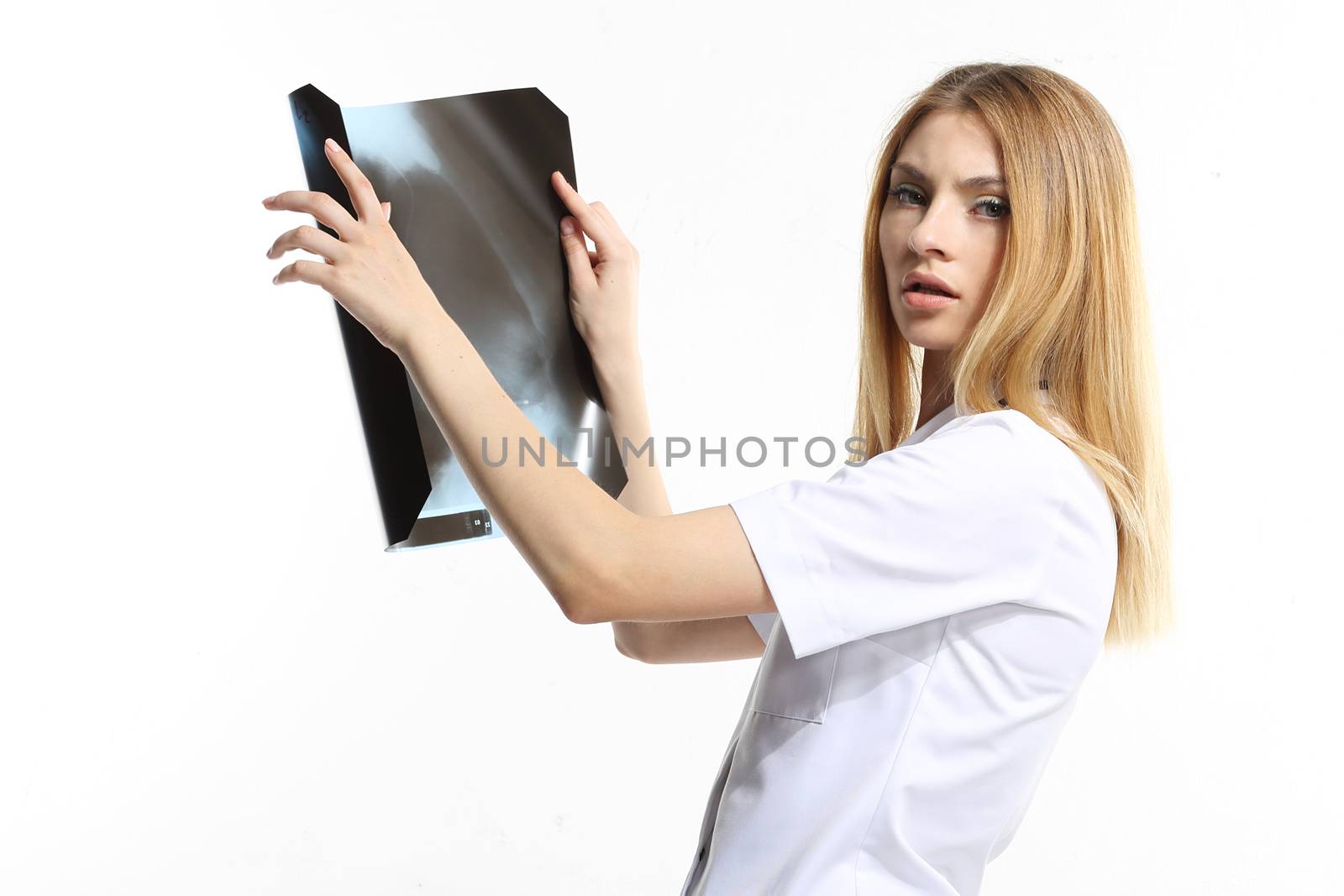 Female doctor examining an x-ray isolated on white background.