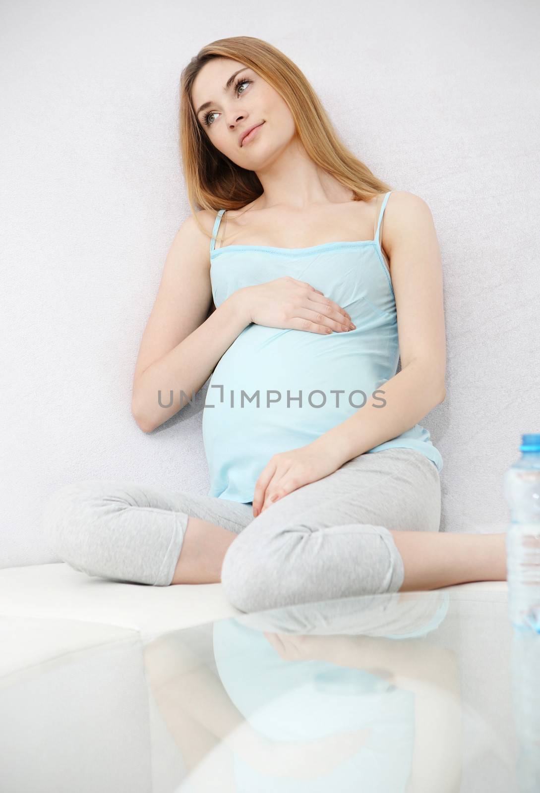 Pregnant woman holding her belly