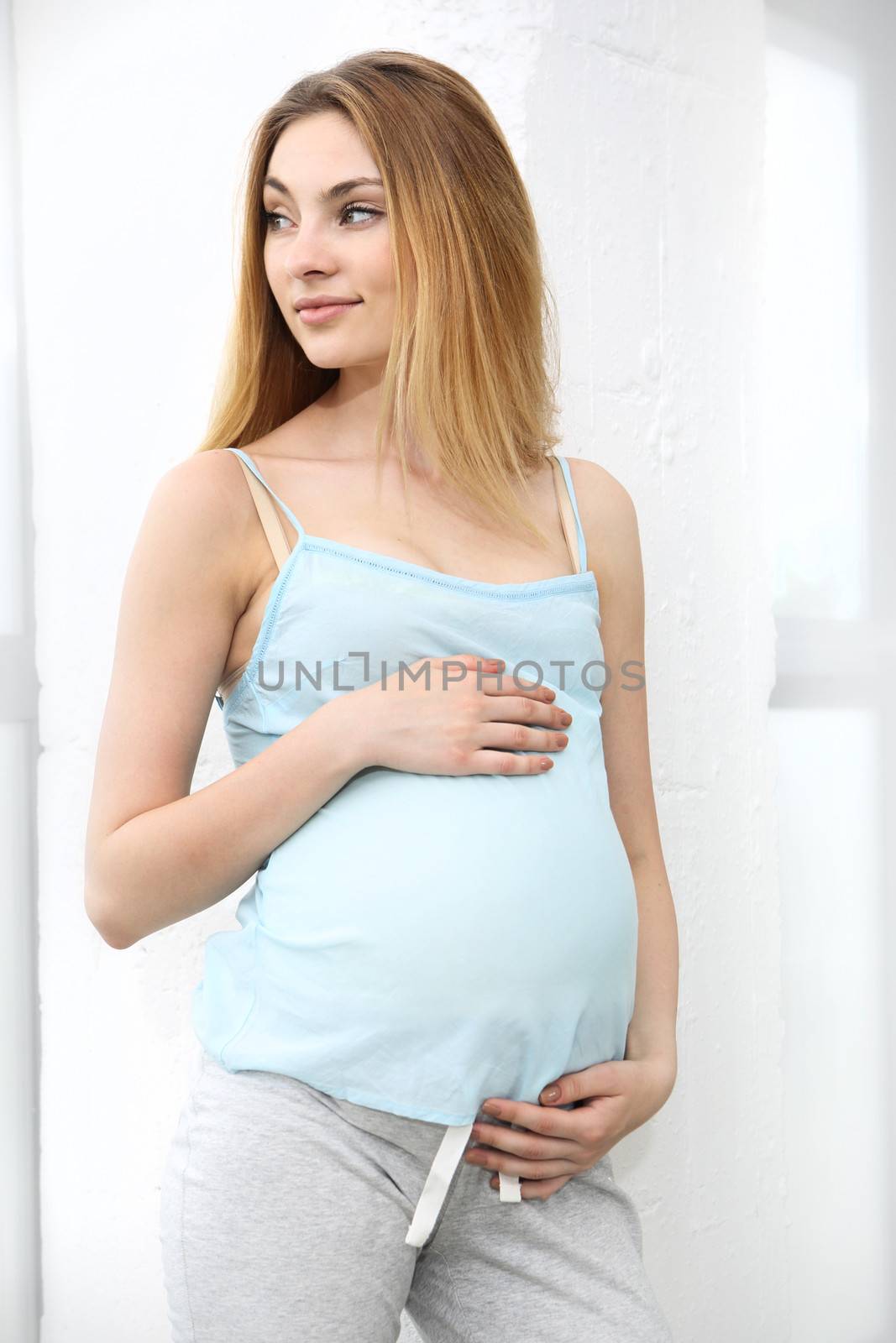 Pregnant woman holding her belly by robert_przybysz