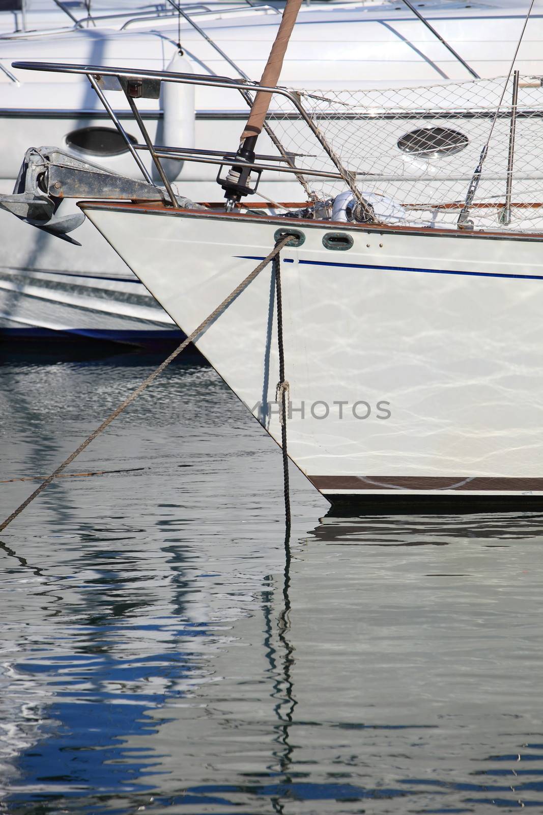 Bows and mooring lines on a pleasure boat or yacht moored in a marina