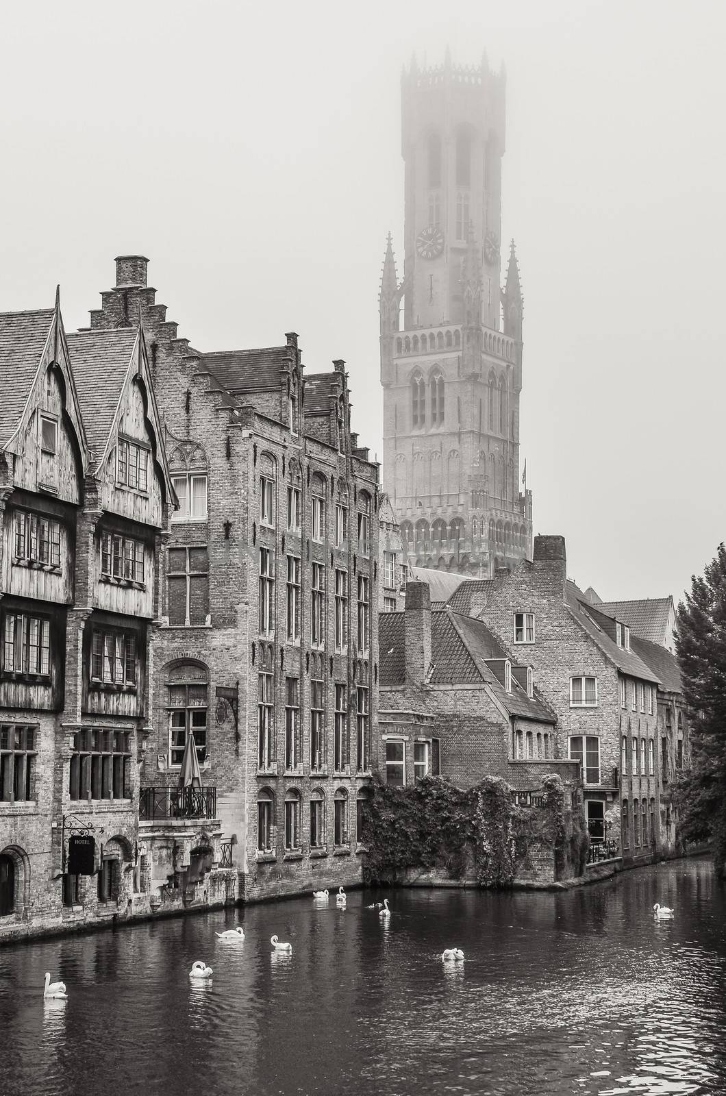 Bruges water canal and Belfry tower in monochrome by martinm303
