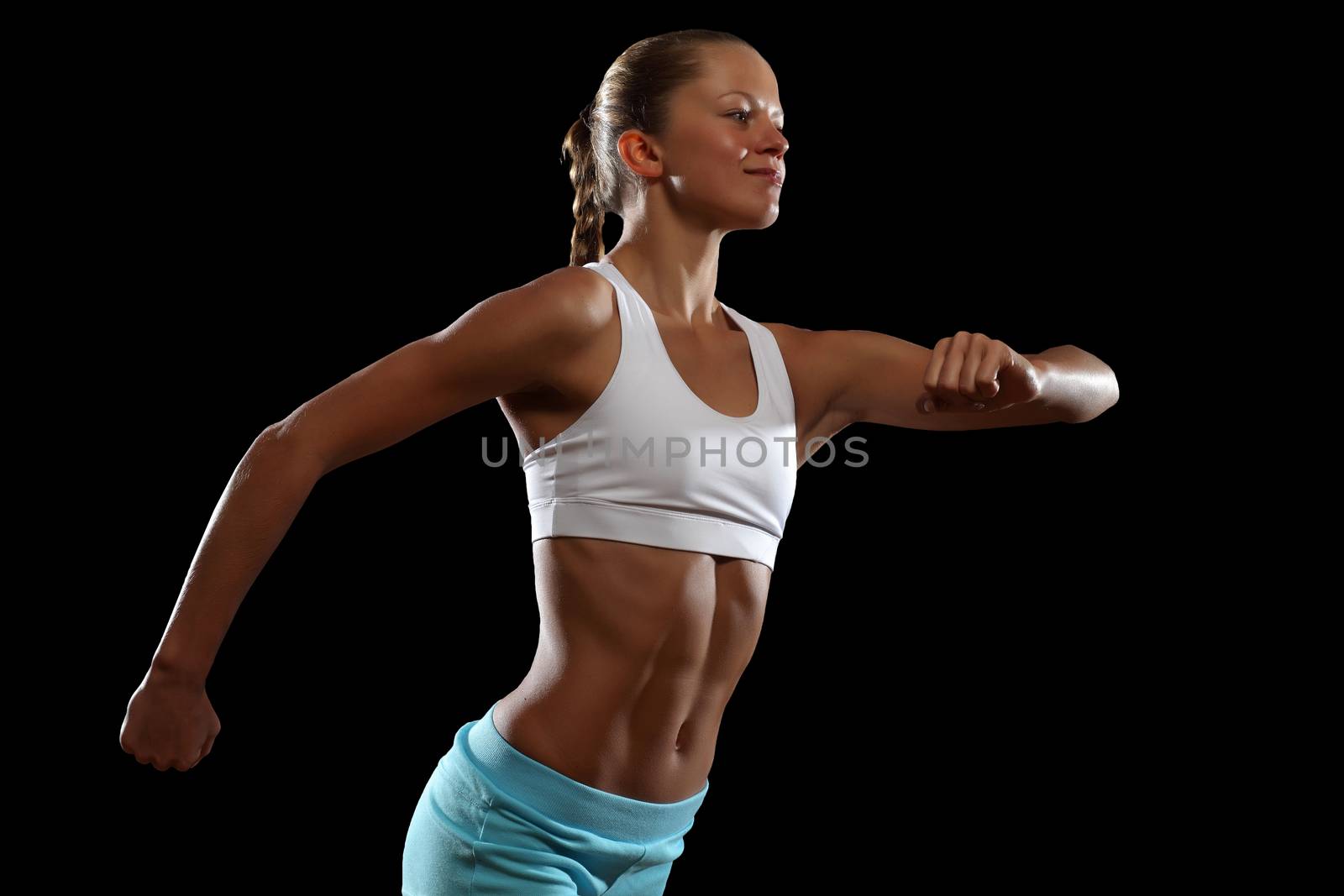 Fitness woman smiling standing against black background