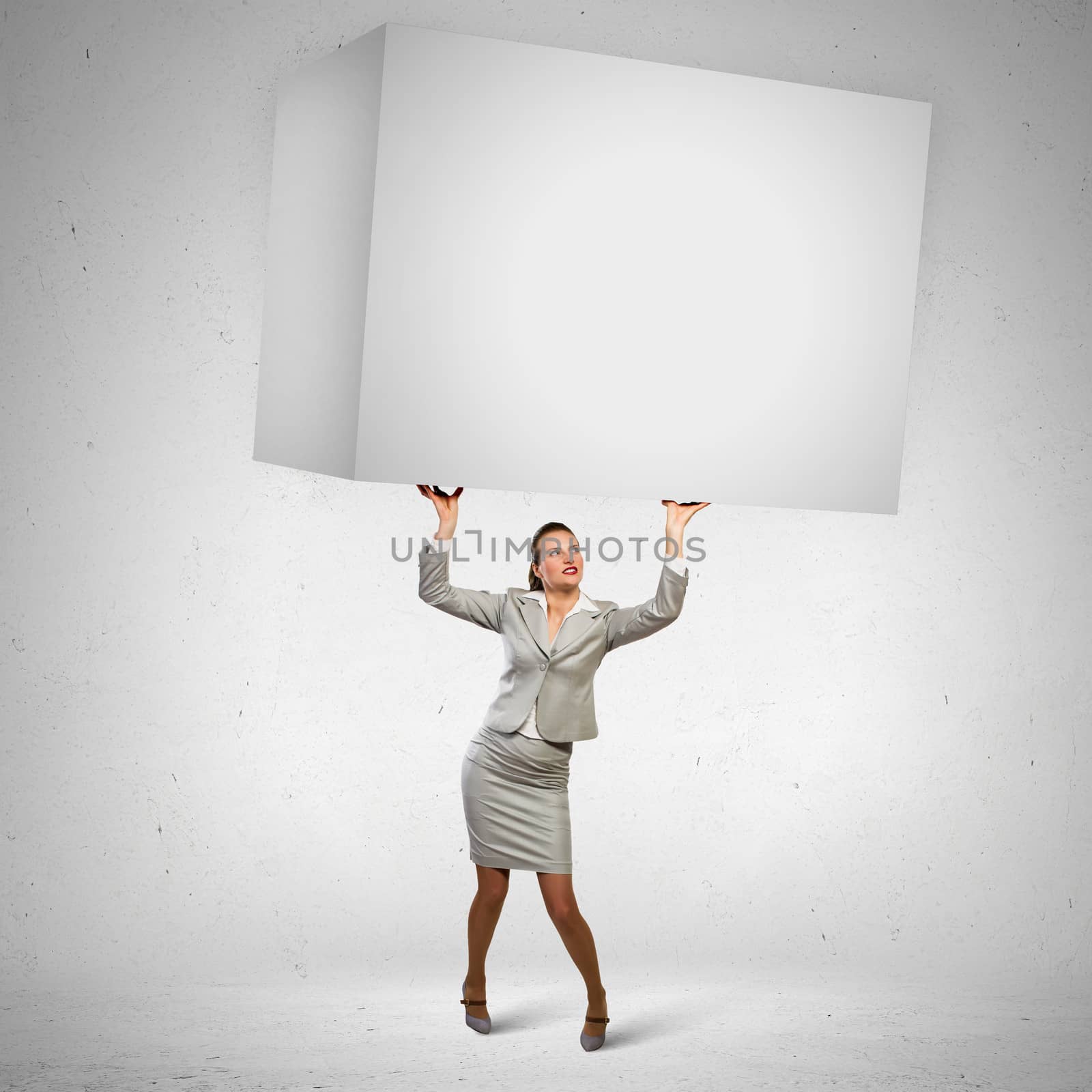 Businesswoman holding heavy cube by sergey_nivens