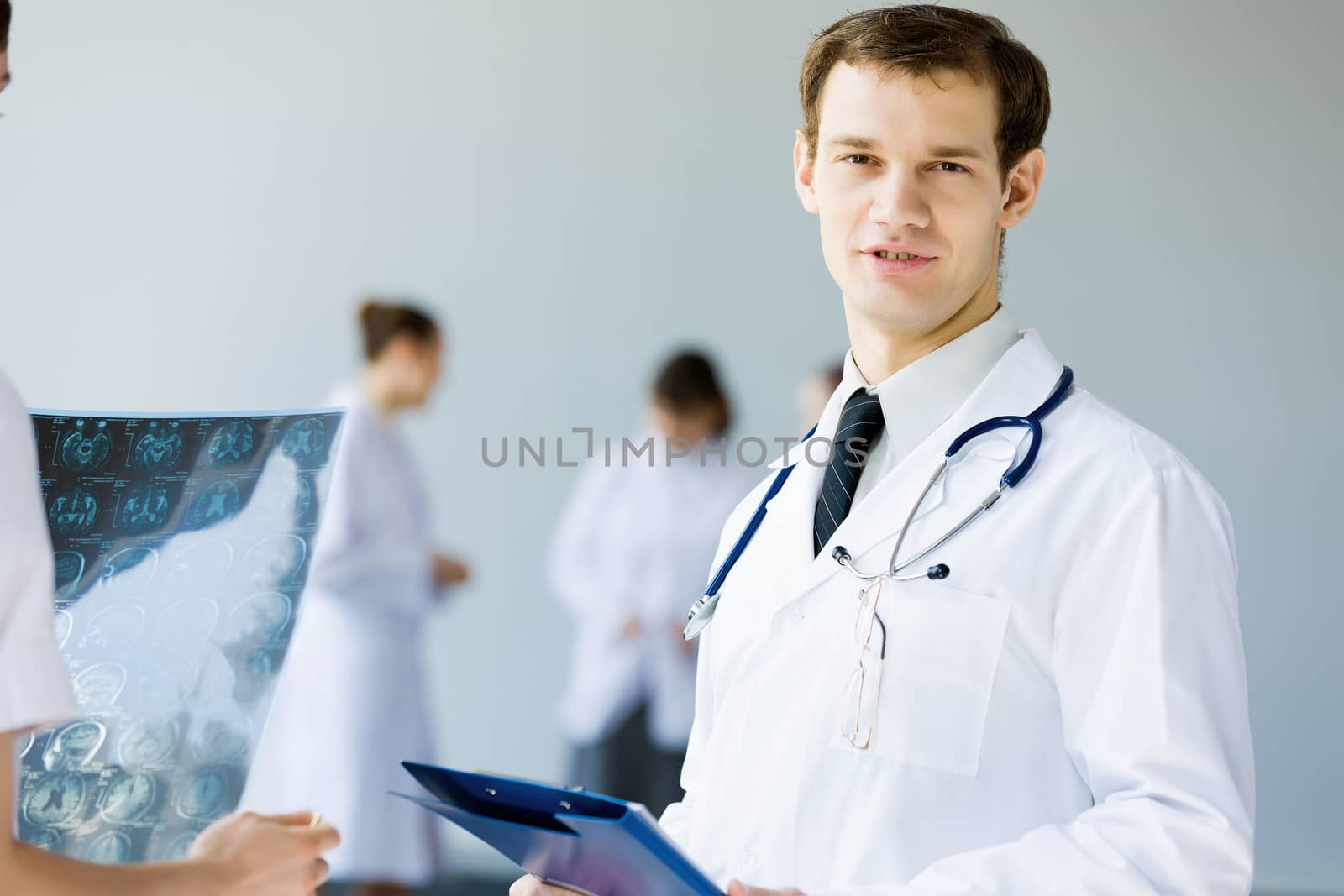 Young doctor in white uniform talking to colleague