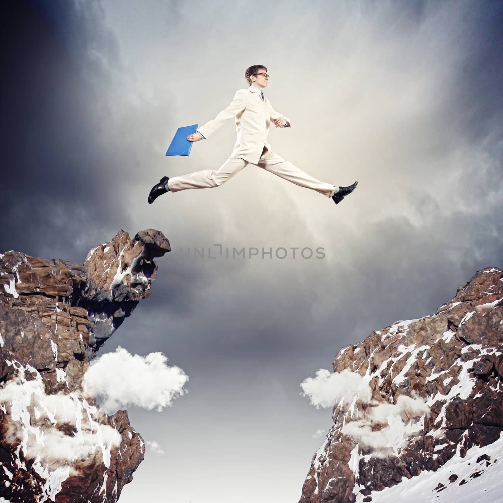 Businessman jumping over gap by sergey_nivens