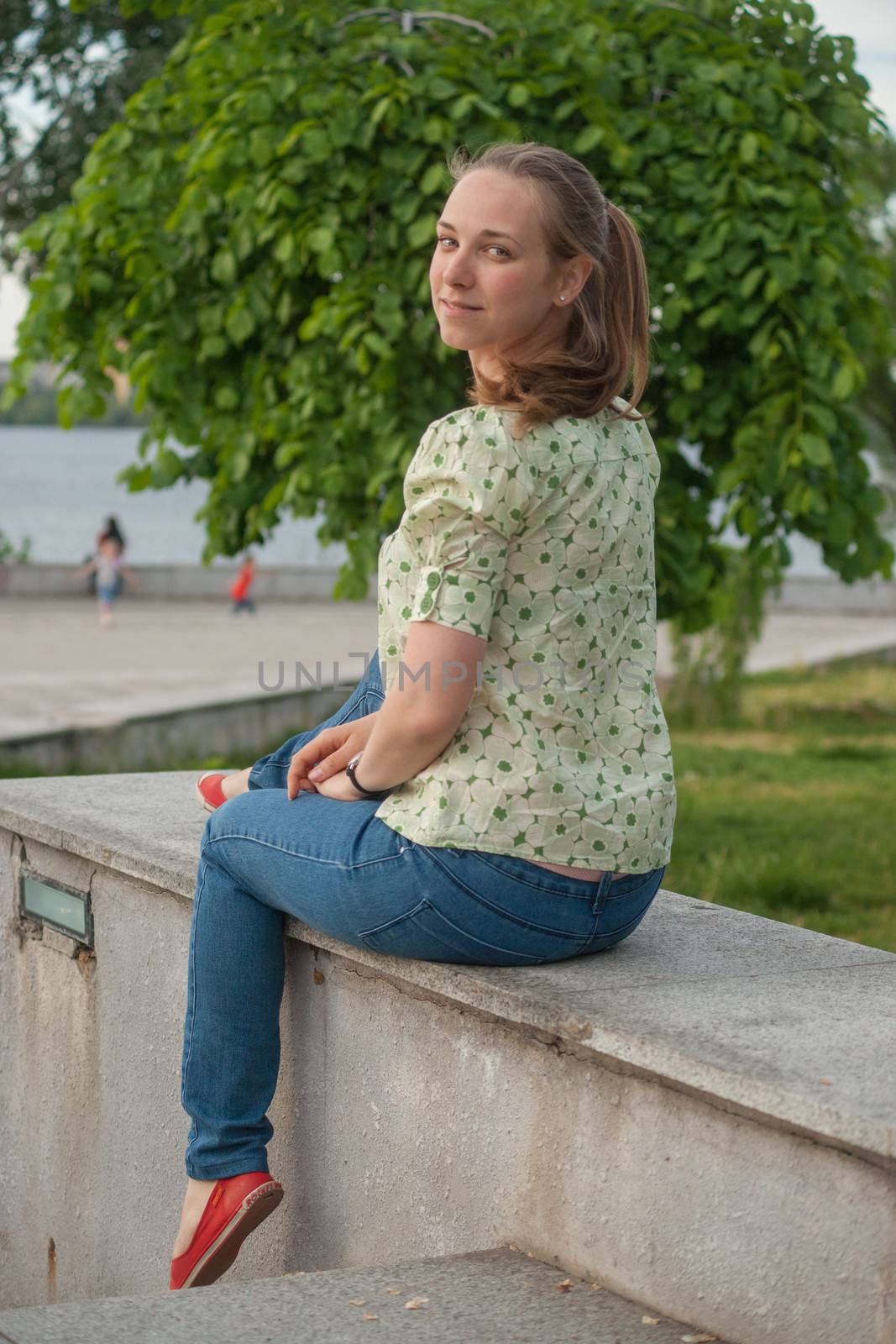 Beautiful young woman in park in summer