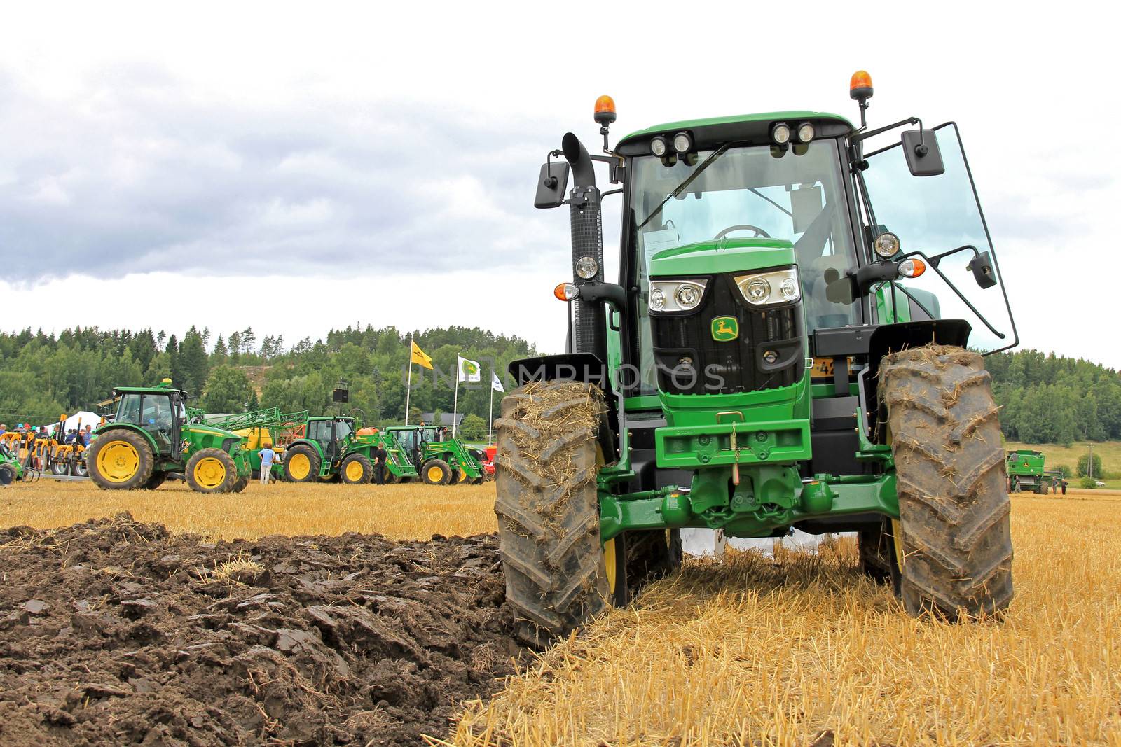 SALO, FINLAND - AUGUST10: John Deere 6150M agricultural tractor and plow at the annual Puontin Peltopaivat Agricultural Show in Salo, Finland on August 10, 2013.