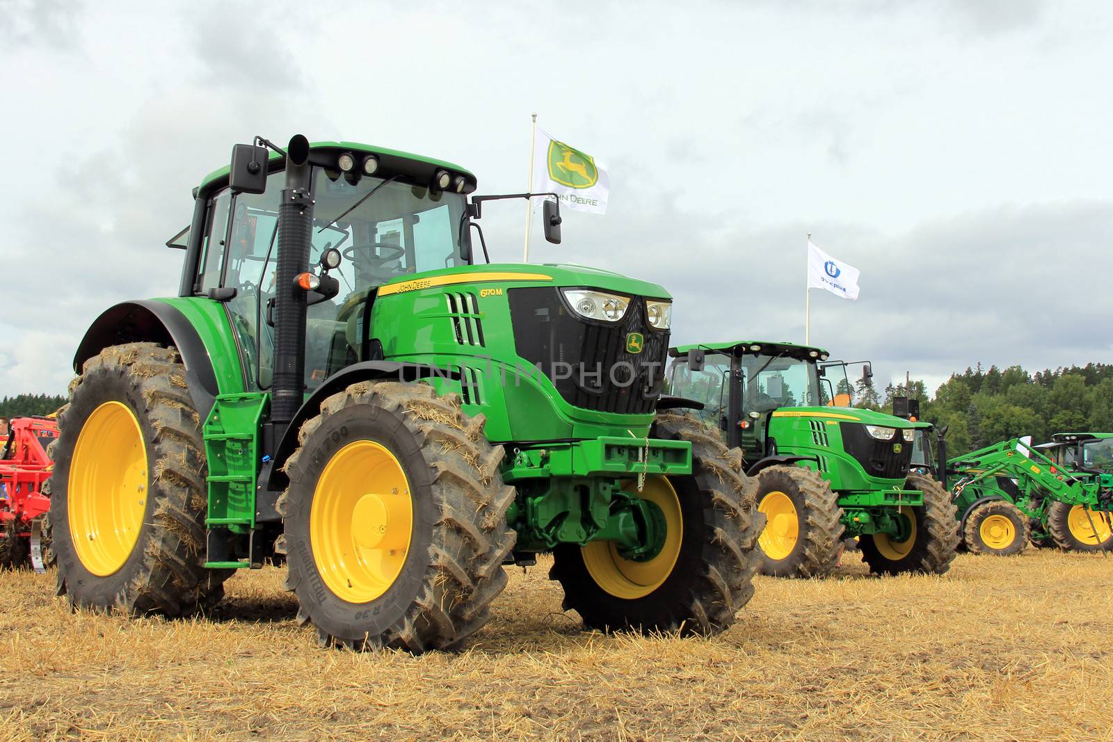 SALO, FINLAND - AUGUST 10: John Deere agricultural tractors 6170M and 6190R displayed at the annual Puontin Peltopaivat Agricultural Show in Salo, Finland on August 10, 2013.