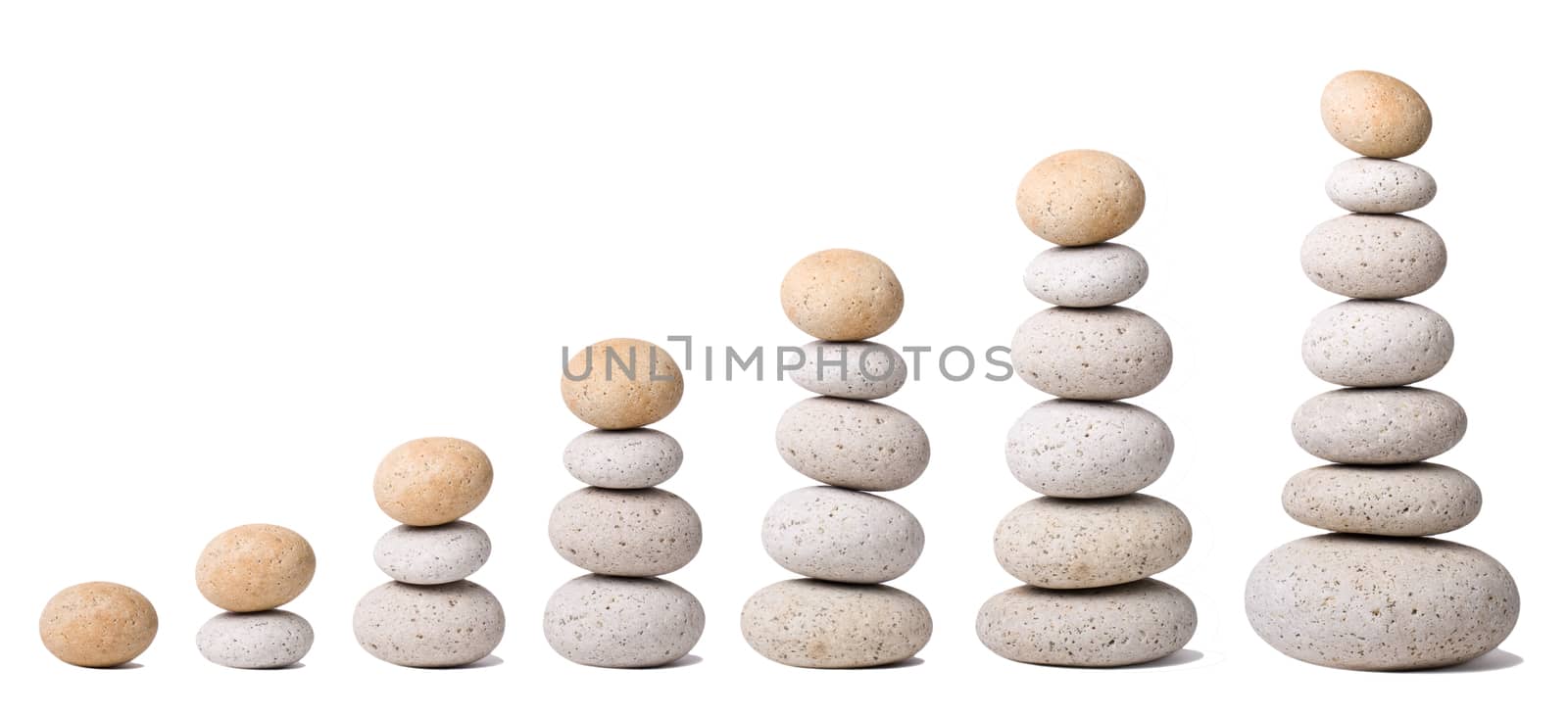 Seven Stacks of Stones on a white Background - a nice Zen-like Background