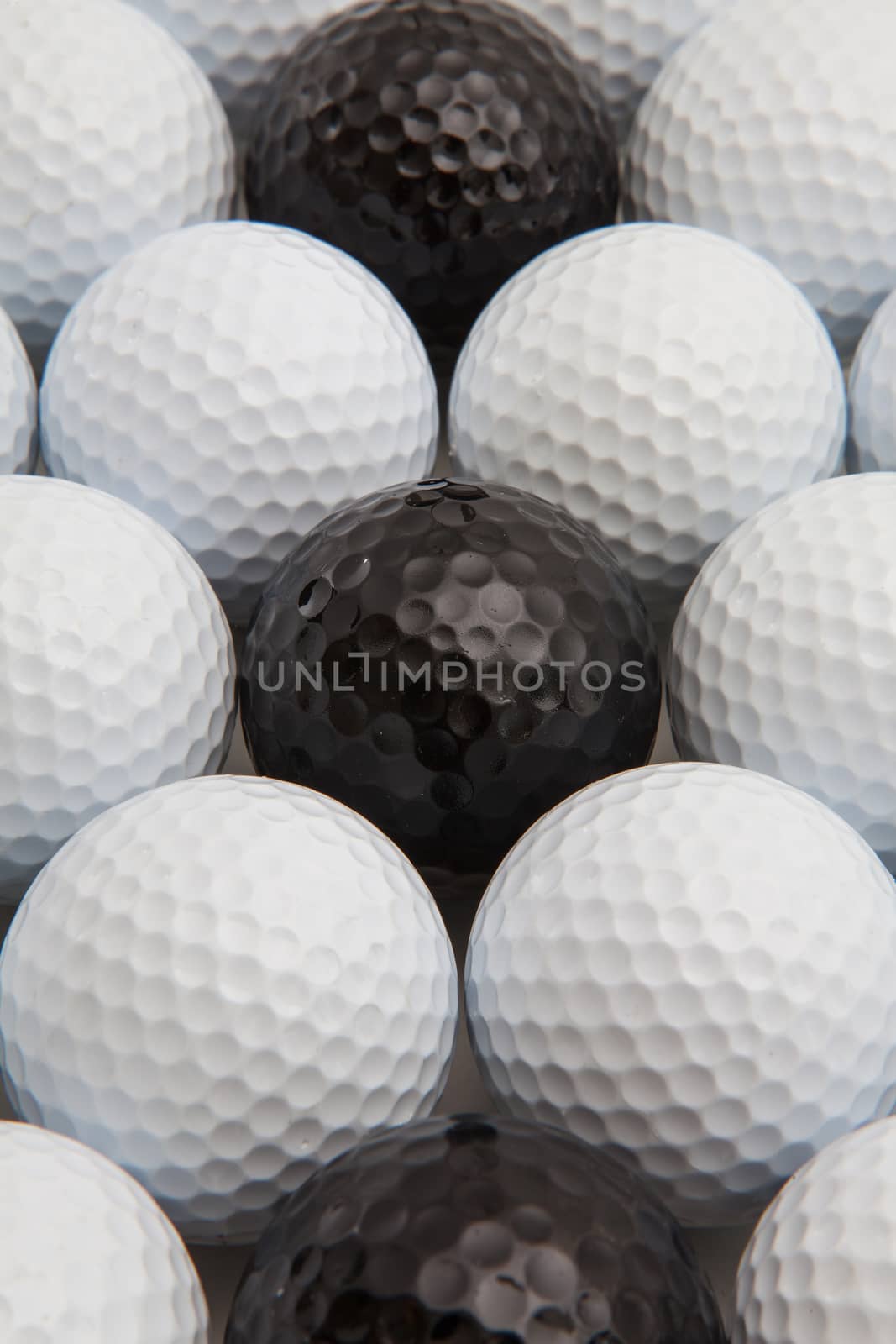 Different golf balls and wooden tees