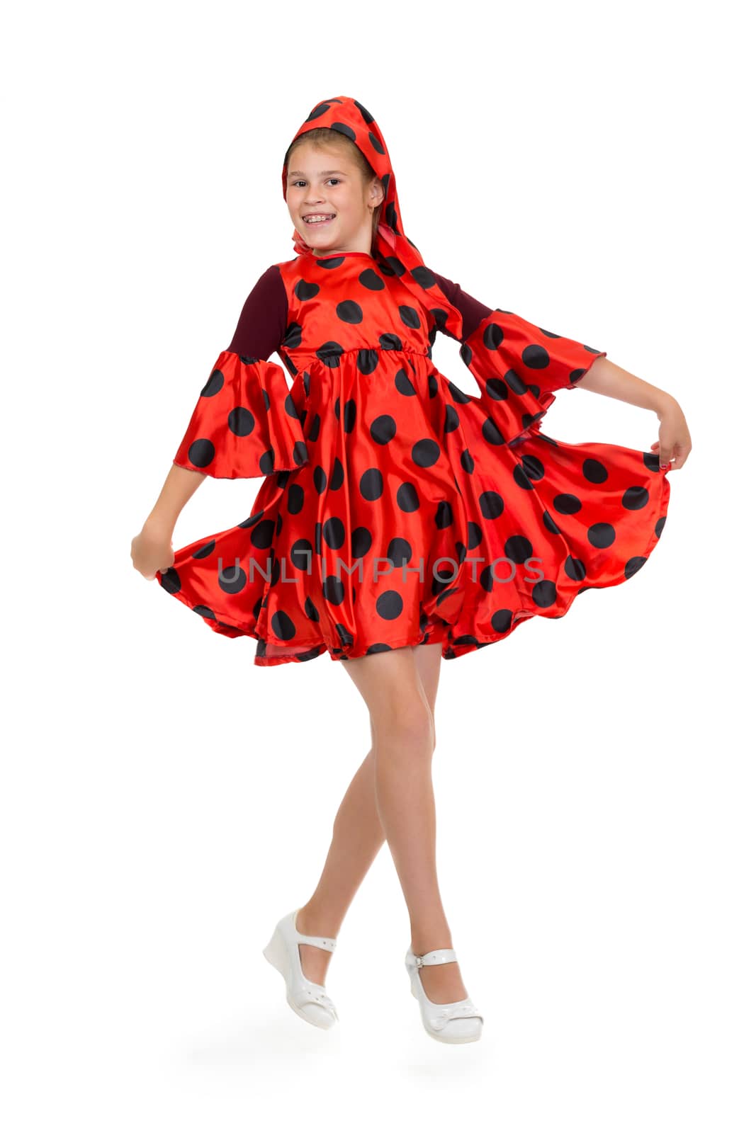 Girl dancing in a red polka-dot dress. Isolate on white.