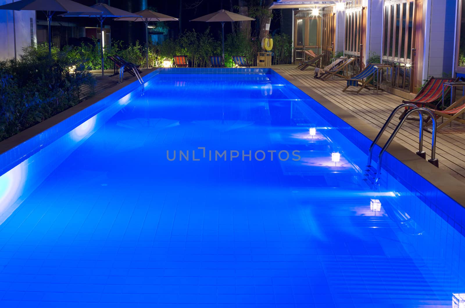 pretty swimming pool in night at a local resort.