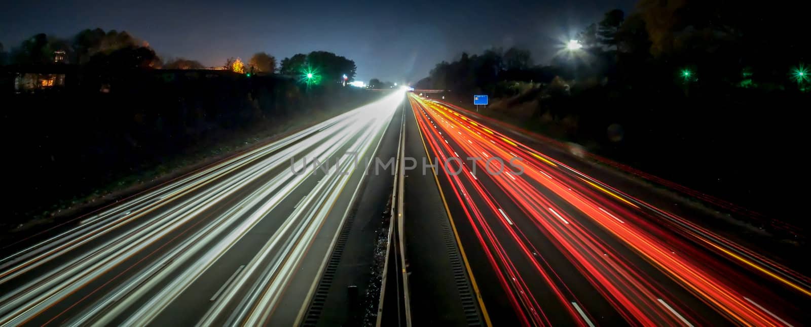 standing in car on side of the road at night in the city