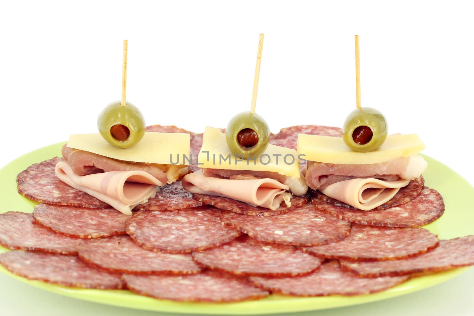 salami ham cheese and olives on dish by goce