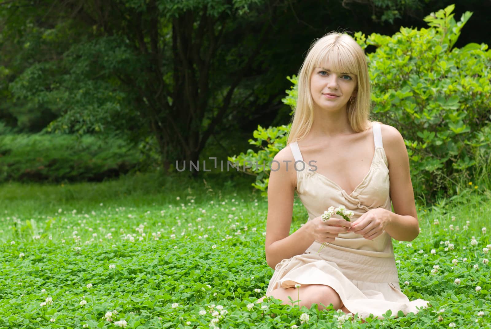 A beautiful girl enjoying the sunny weather in clover meadow