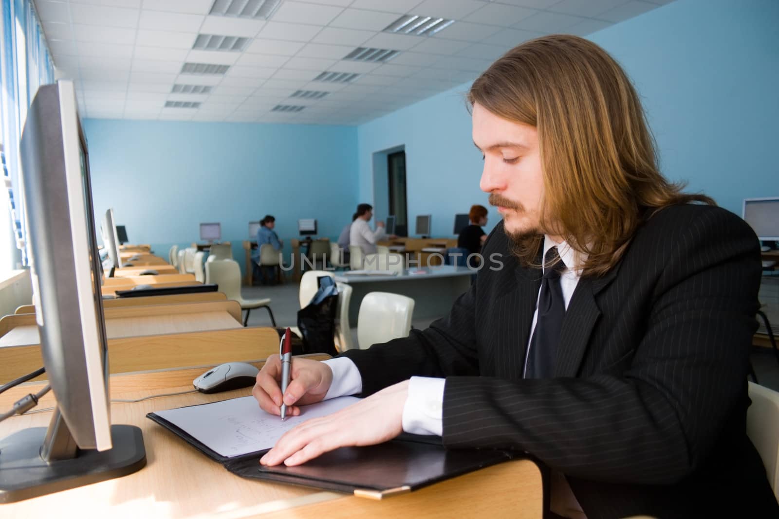 Young businessman writing some documents.