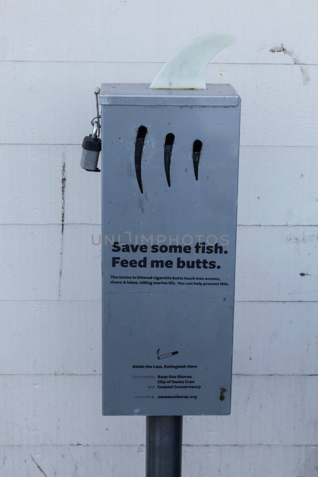 Cigarette butts collection metal box on a pier.