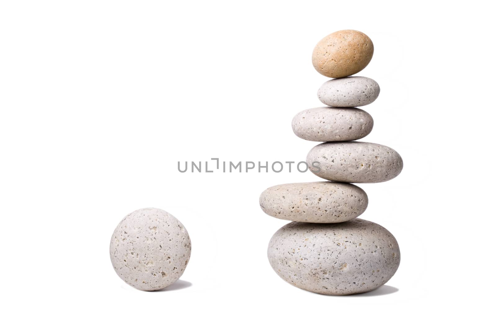 A stack of slightly off-balanced zen stones isolated on white background.